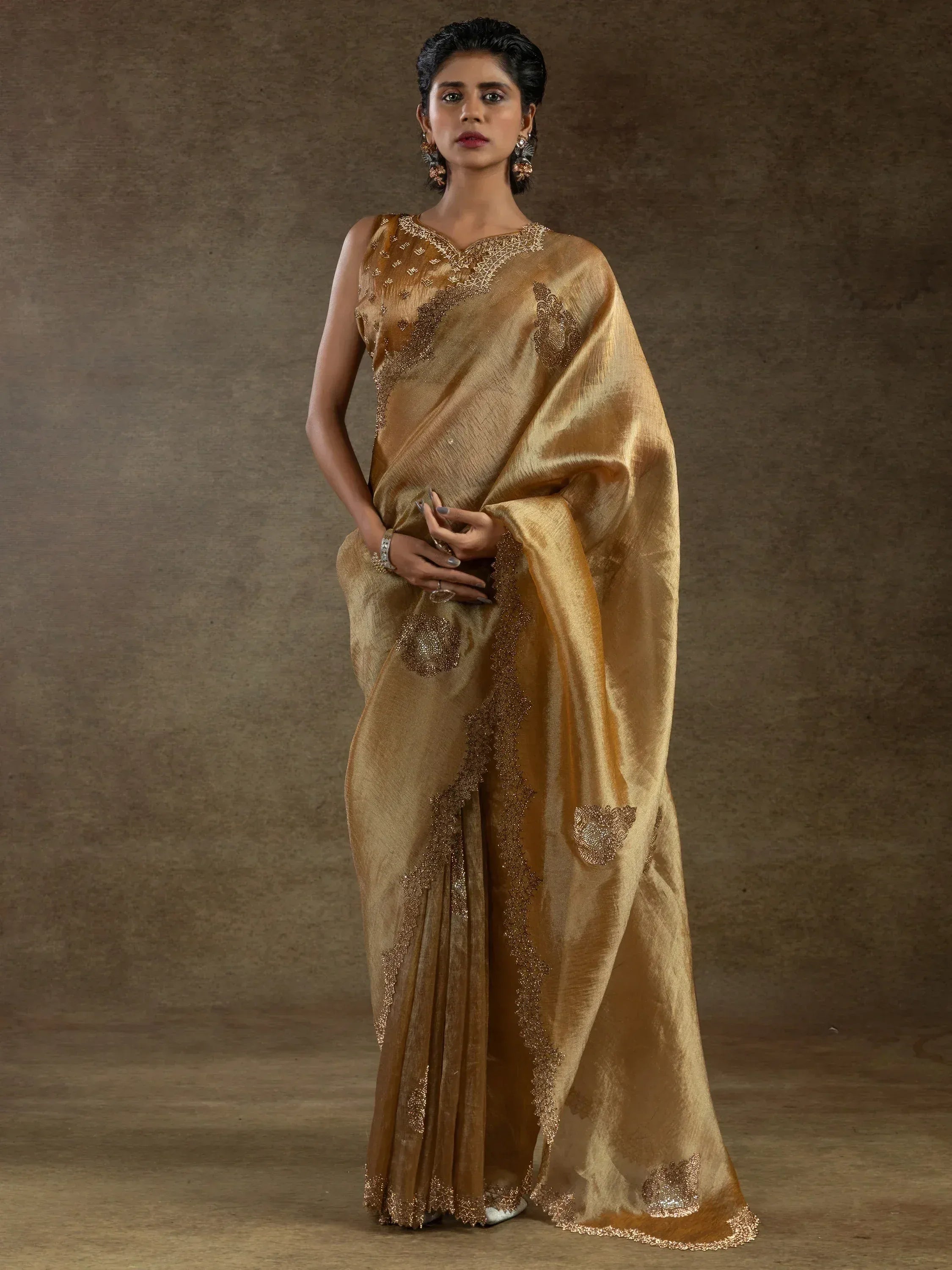 Elegant gold saree with intricate embroidery and shimmering detailing for ethnic occasions