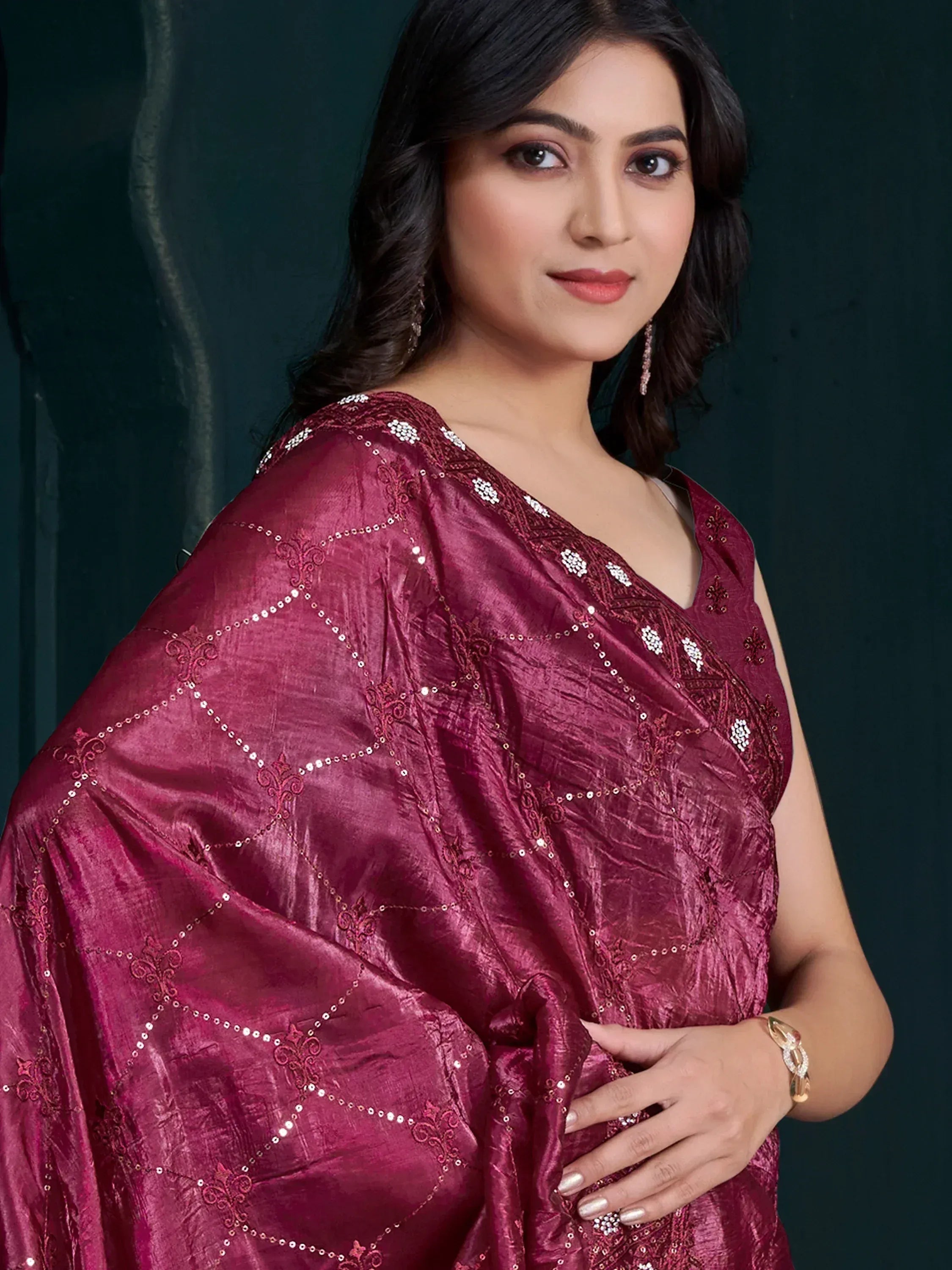 Elegant maroon saree with intricate embroidery and sequin detailing, perfect for festive occasions.