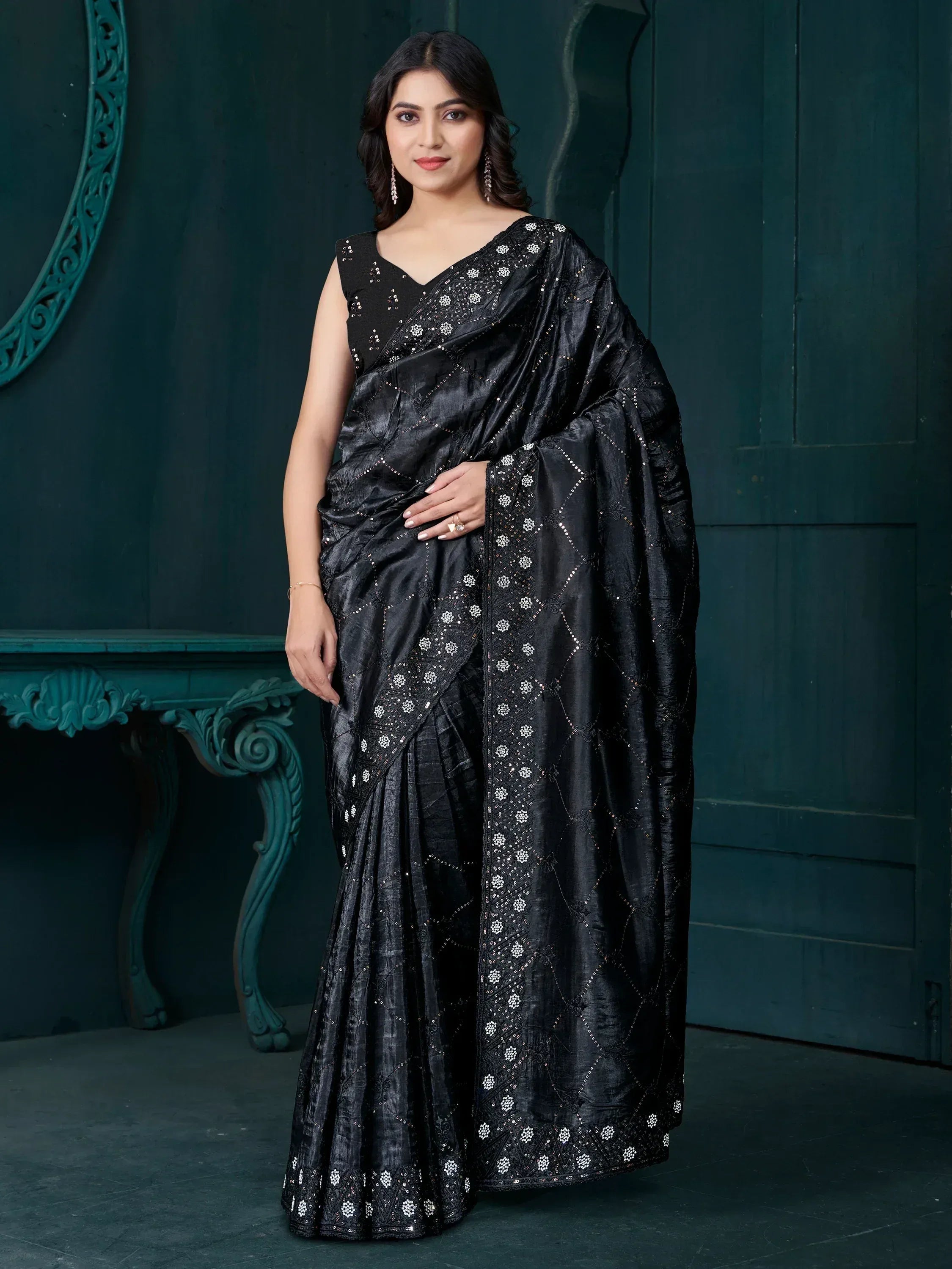 Elegant black saree with intricate white embroidery and sequin detailing, perfect for ethnic occasions.