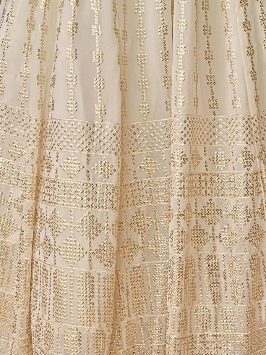 Cream and gold embroidered lehenga skirt with intricate geometric patterns and detailed zari work.