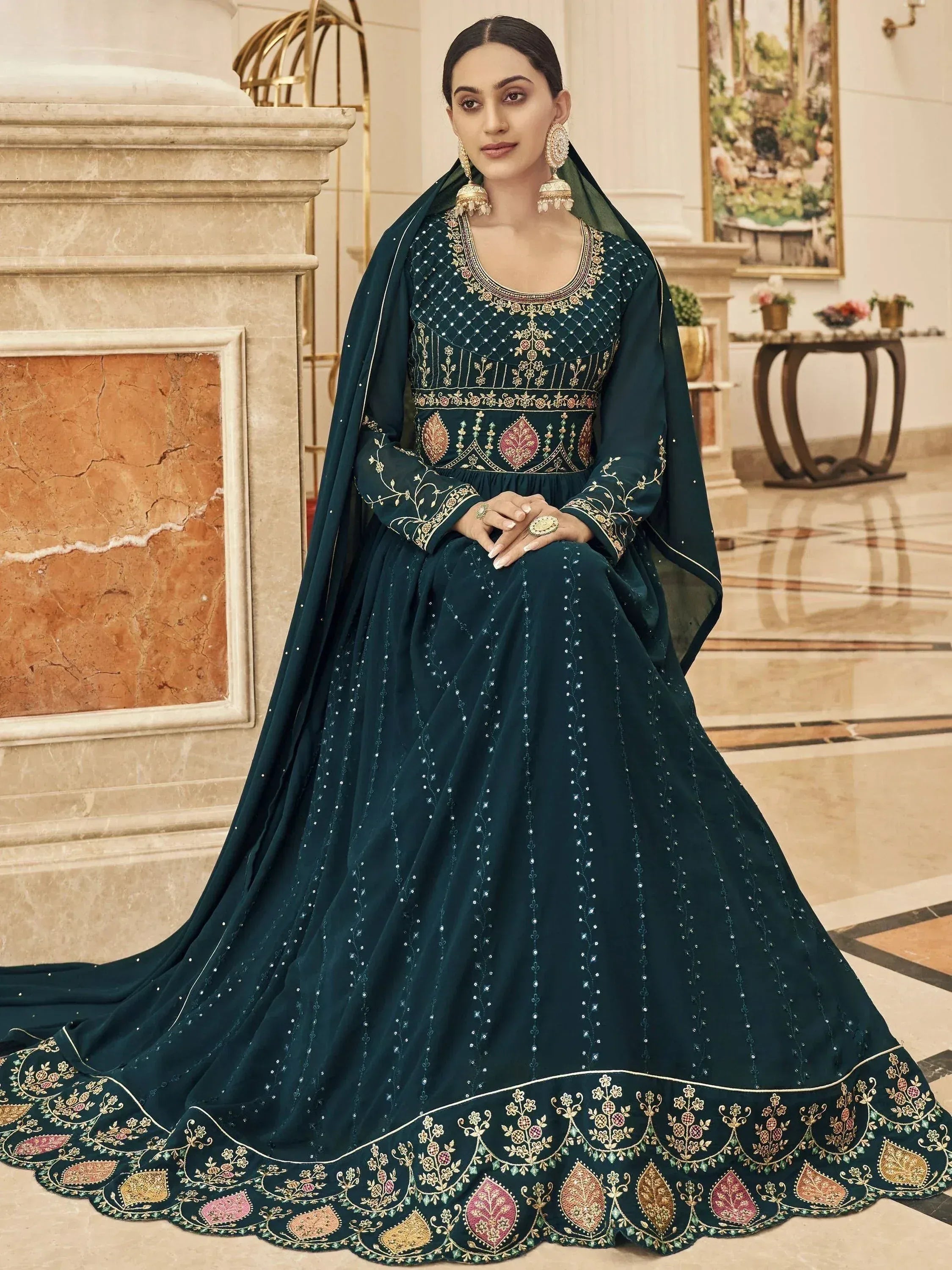 Elegant dark green embroidered anarkali gown with gold floral motifs and matching dupatta, perfect for Indian ethnic occasions.