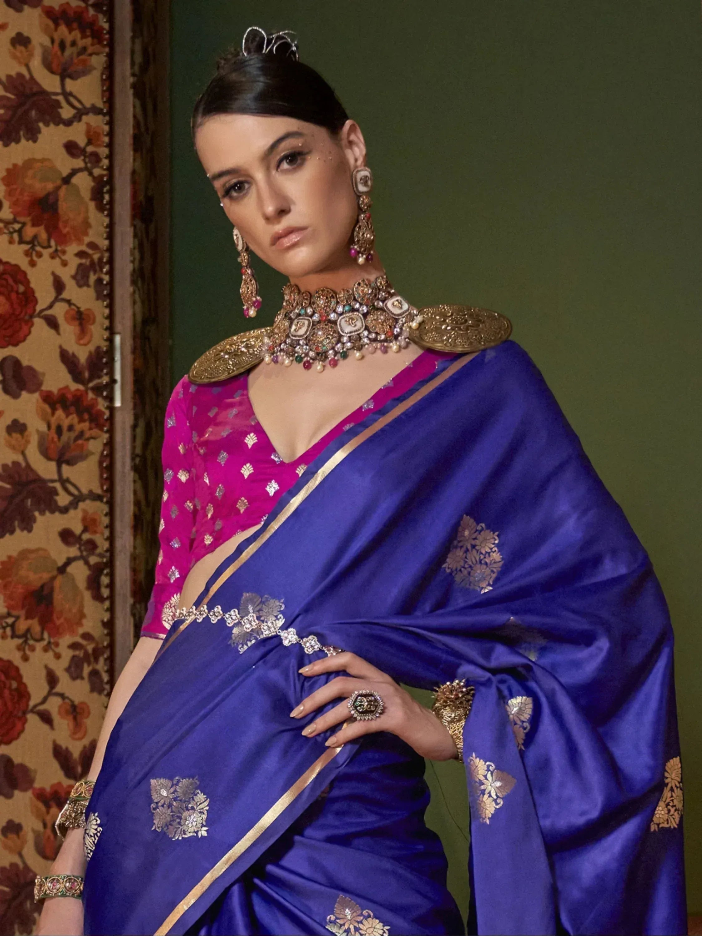 Royal blue silk saree with gold floral embroidery, paired with pink blouse and traditional Indian jewelry
