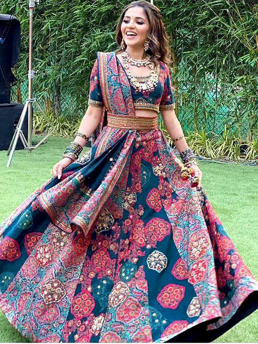 Woman in vibrant printed lehenga choli with gold embroidery, perfect for Indian ethnic occasions