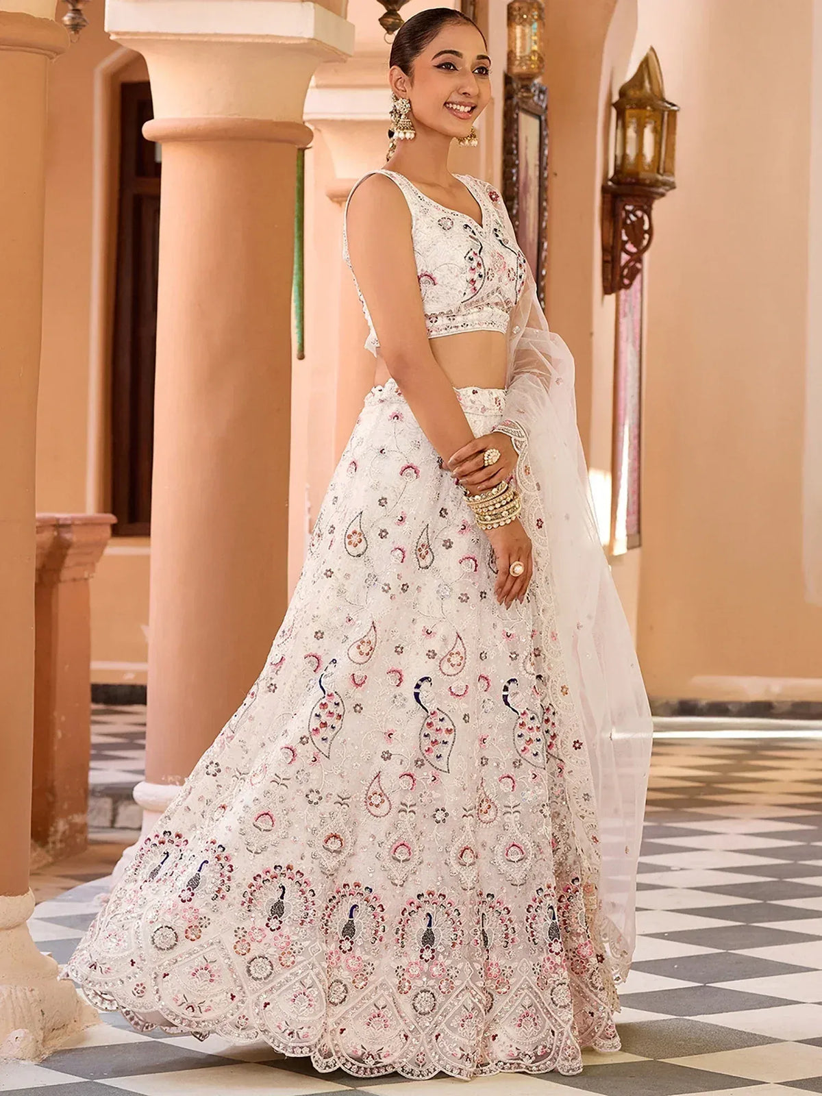 Elegant white lehenga choli with peacock embroidery, perfect for Indian ethnic wear