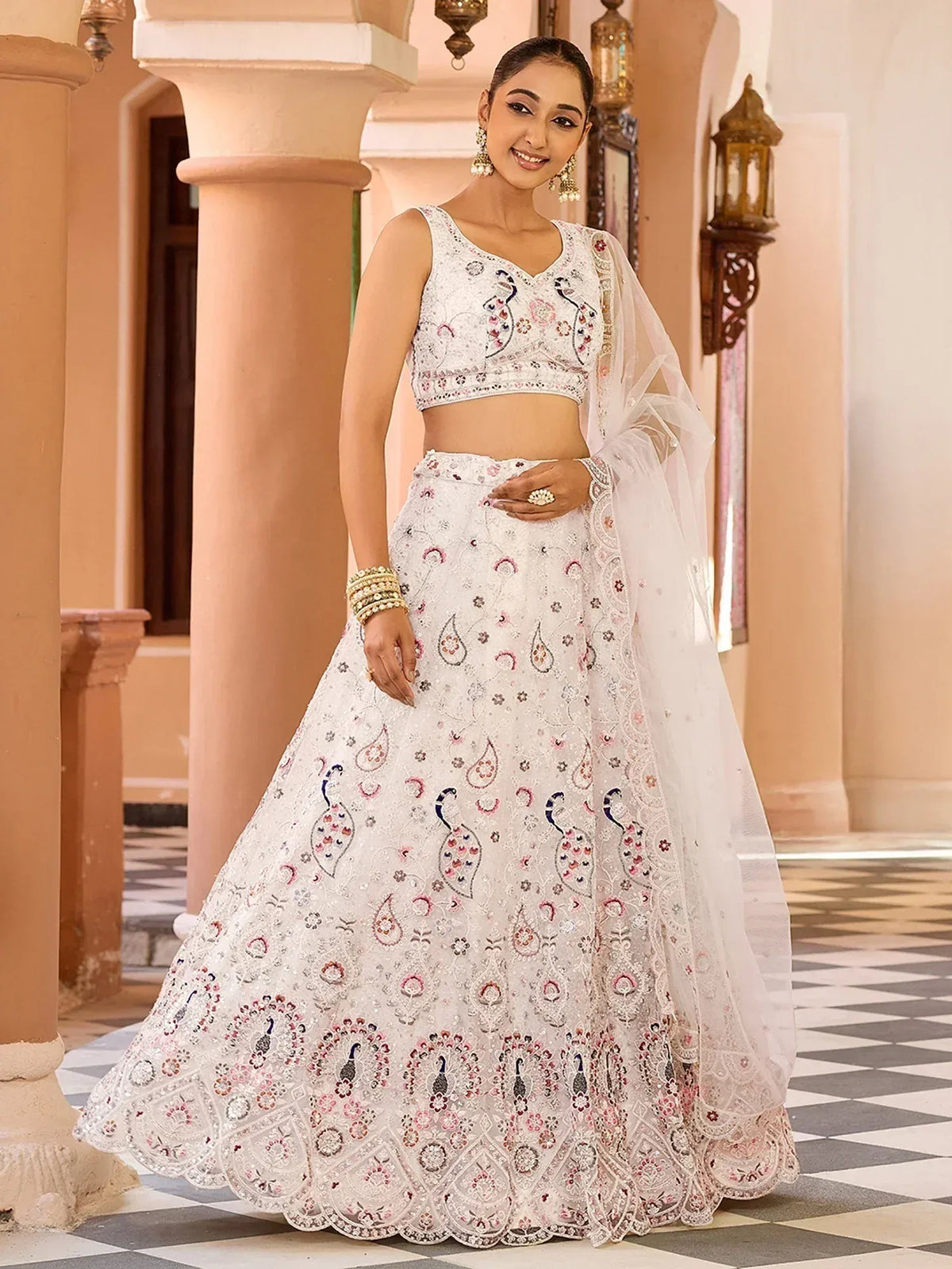 Elegant white lehenga choli with peacock embroidery and floral motifs, perfect for Indian ethnic wear.