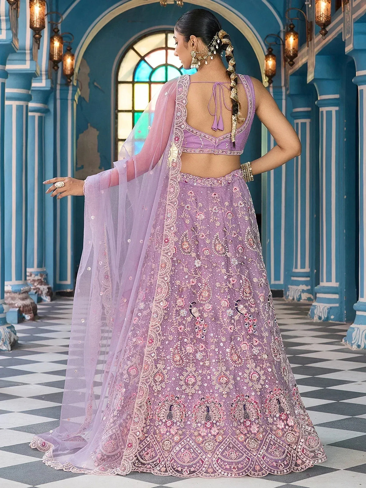 Elegant lavender lehenga choli with intricate embroidery and sheer dupatta, perfect for Indian ethnic wear.