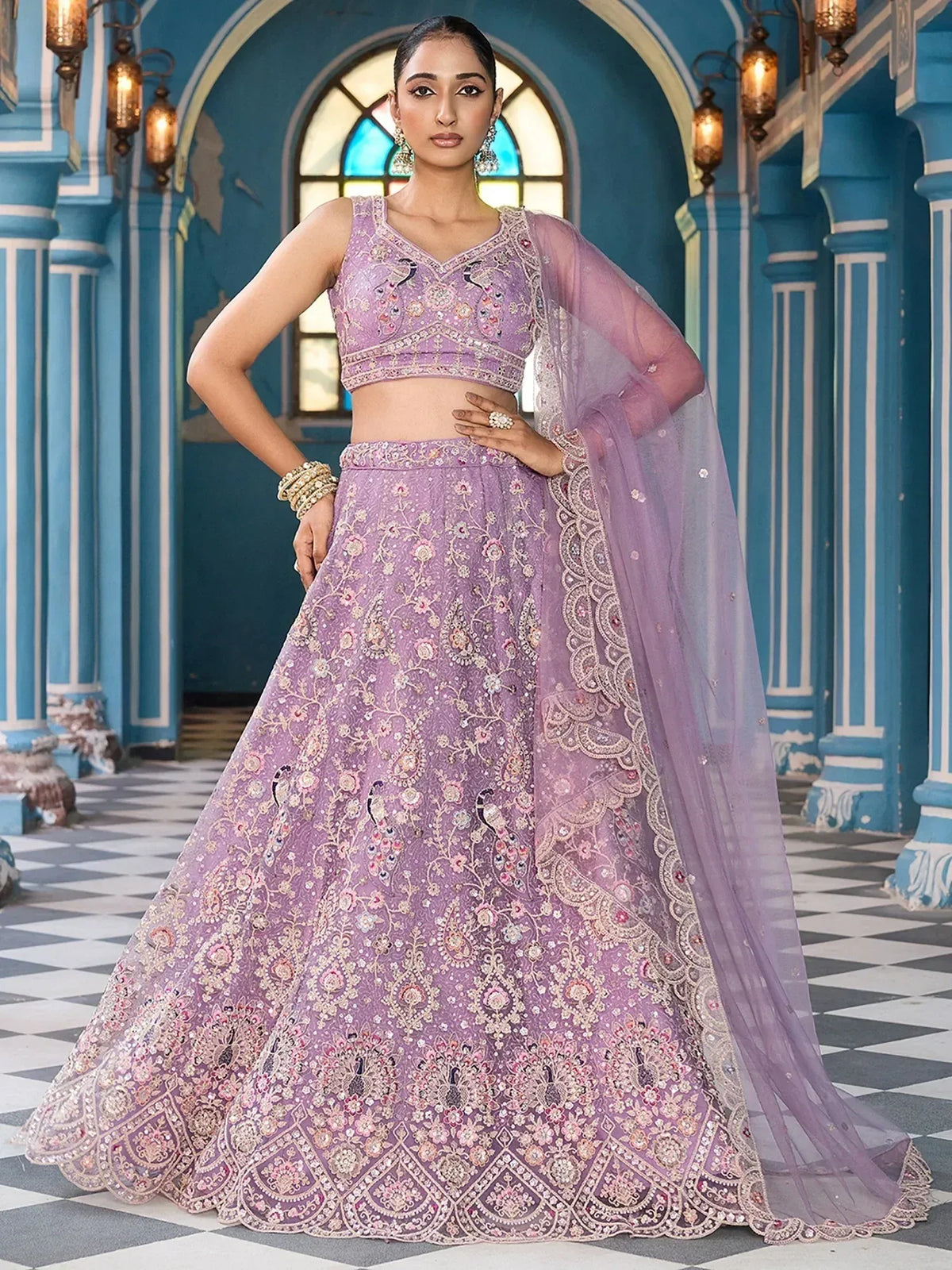 Elegant lavender lehenga choli with intricate embroidery and peacock motifs, perfect for Indian ethnic wear.