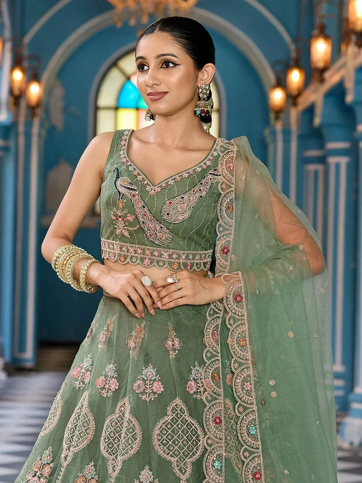 Elegant green lehenga choli with peacock embroidery and floral motifs, perfect for Indian ethnic occasions.