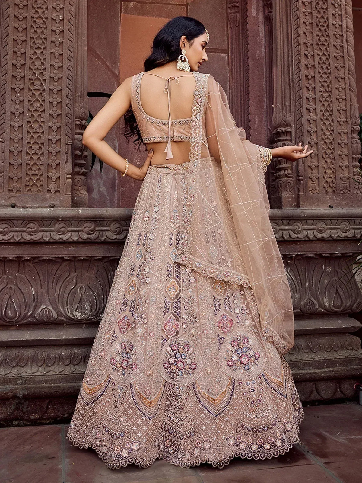 Elegant beige lehenga choli with intricate floral embroidery and sheer dupatta, perfect for Indian ethnic wear.