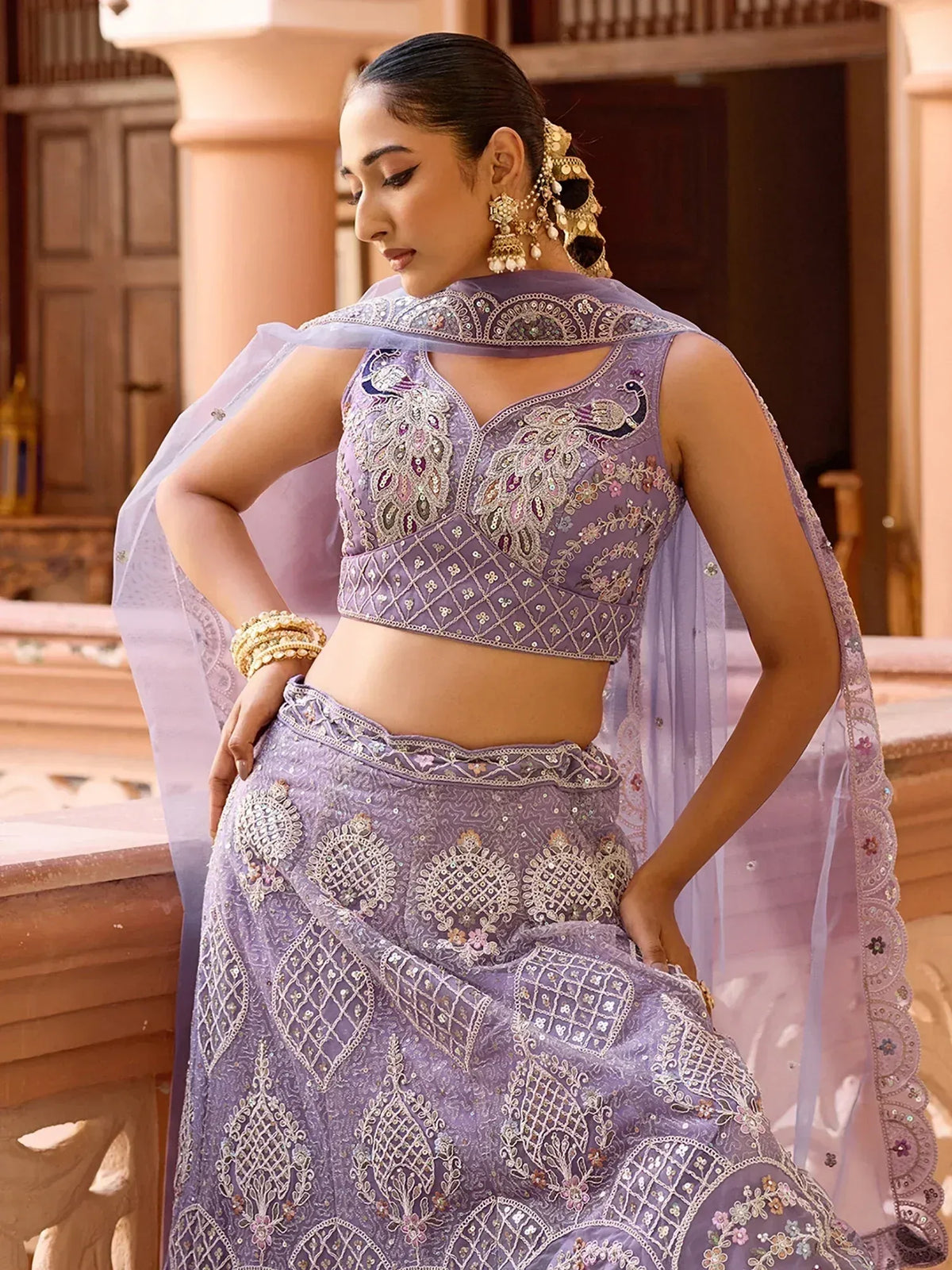Elegant lavender lehenga choli with intricate embroidery and peacock motifs, perfect for Indian ethnic wear.