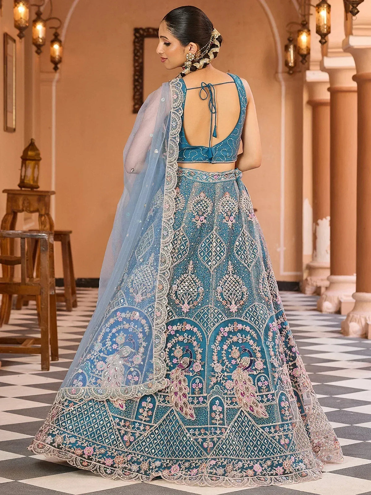 Blue embroidered lehenga choli with peacock motifs and sheer dupatta for Indian ethnic wear