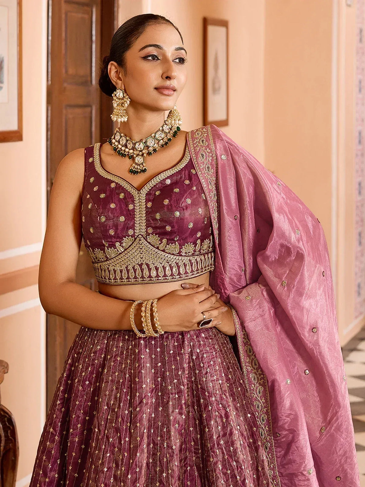 Elegant maroon lehenga choli with gold embroidery and pink dupatta, perfect for Indian ethnic wear