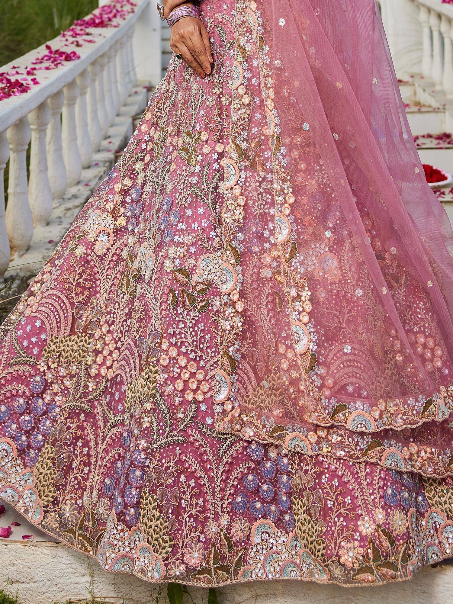 Pink embroidered lehenga choli with floral motifs, perfect for Indian weddings and festive occasions.