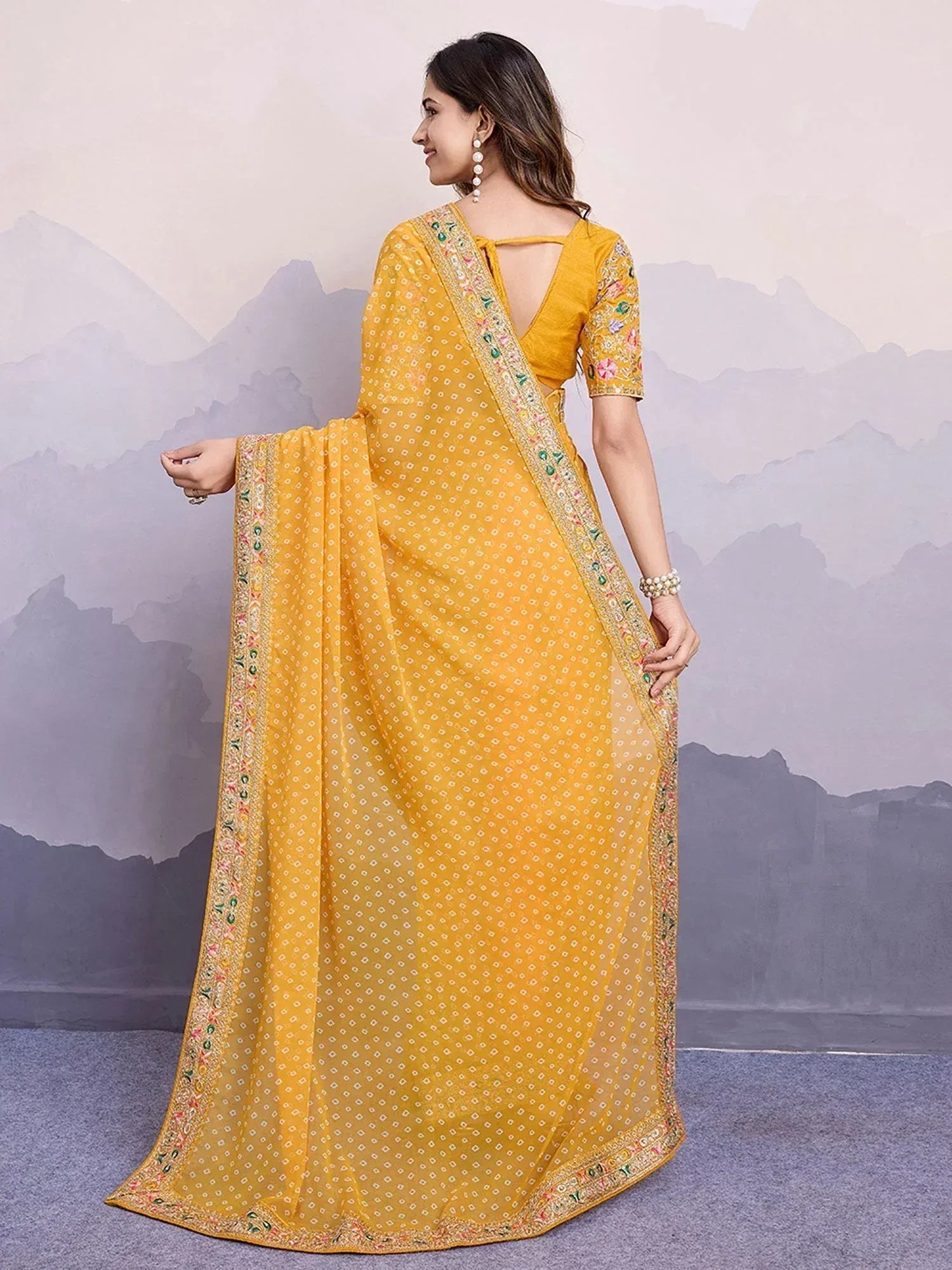 Yellow embroidered saree with floral border, perfect for Indian ethnic wear occasions