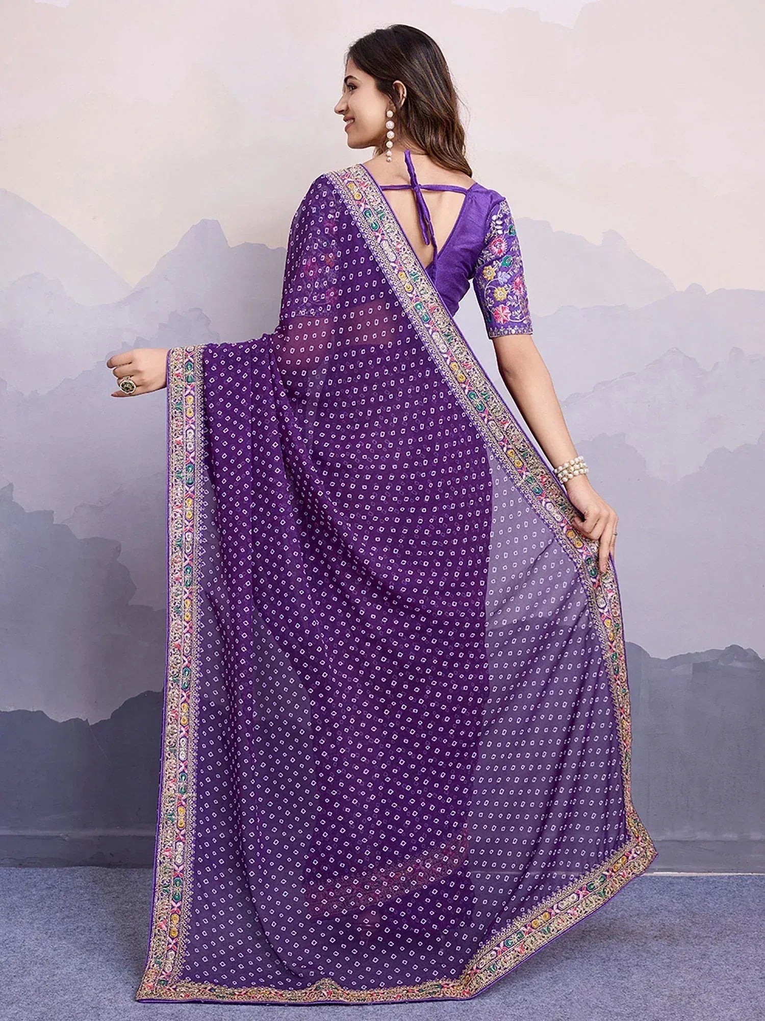 Purple printed saree with floral embroidery and embellished border, paired with matching blouse for ethnic wear