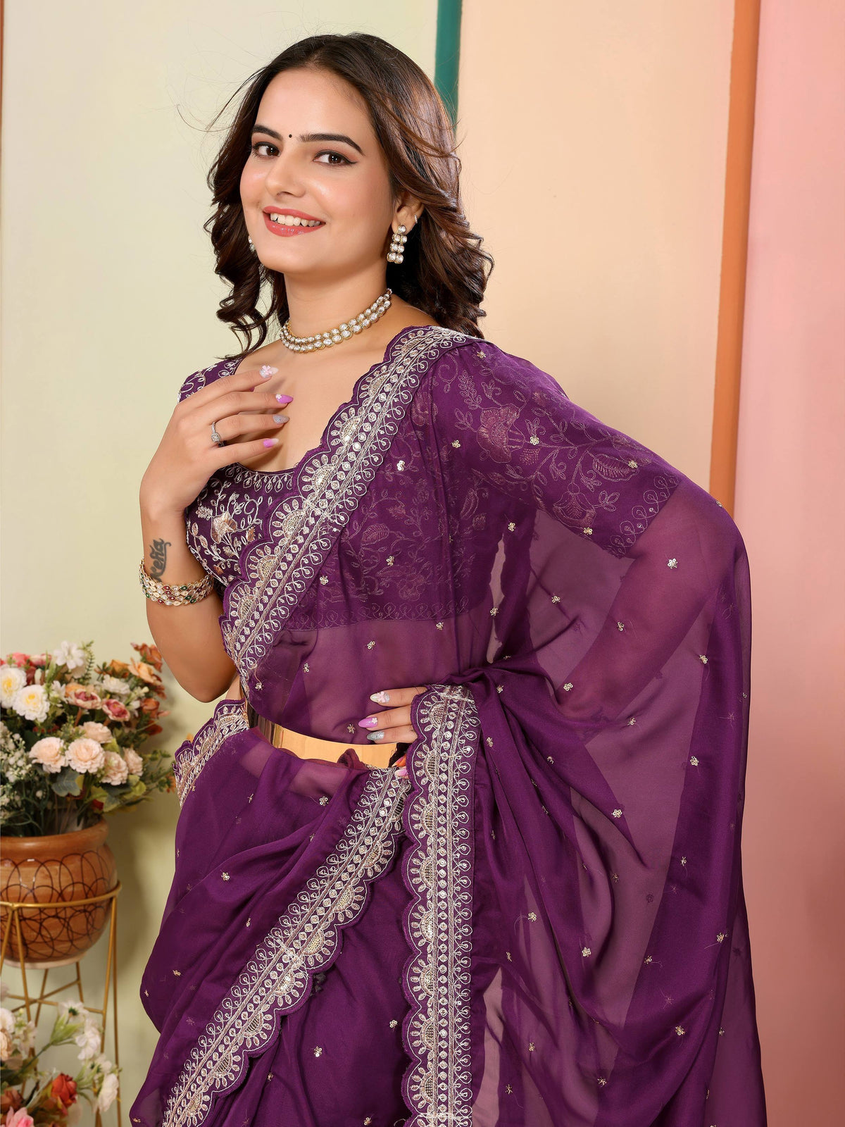 Purple embroidered saree with gold detailing, perfect for ethnic occasions and festive wear.