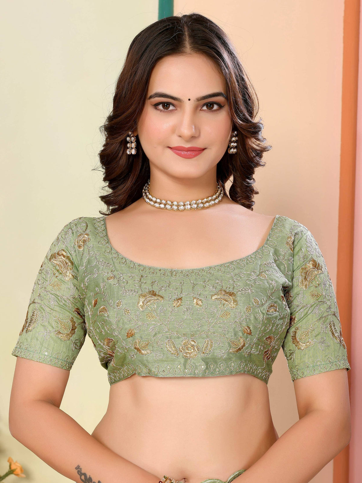 Green embroidered crop top with gold floral design, perfect for ethnic wear and designer lehenga choli sets.