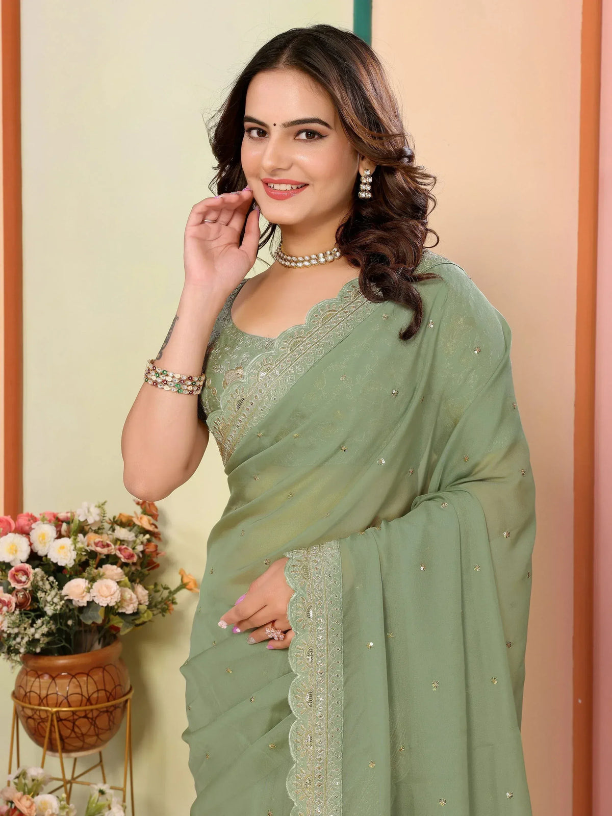 Woman in elegant sage green saree with gold embroidery, perfect for Indian ethnic occasions