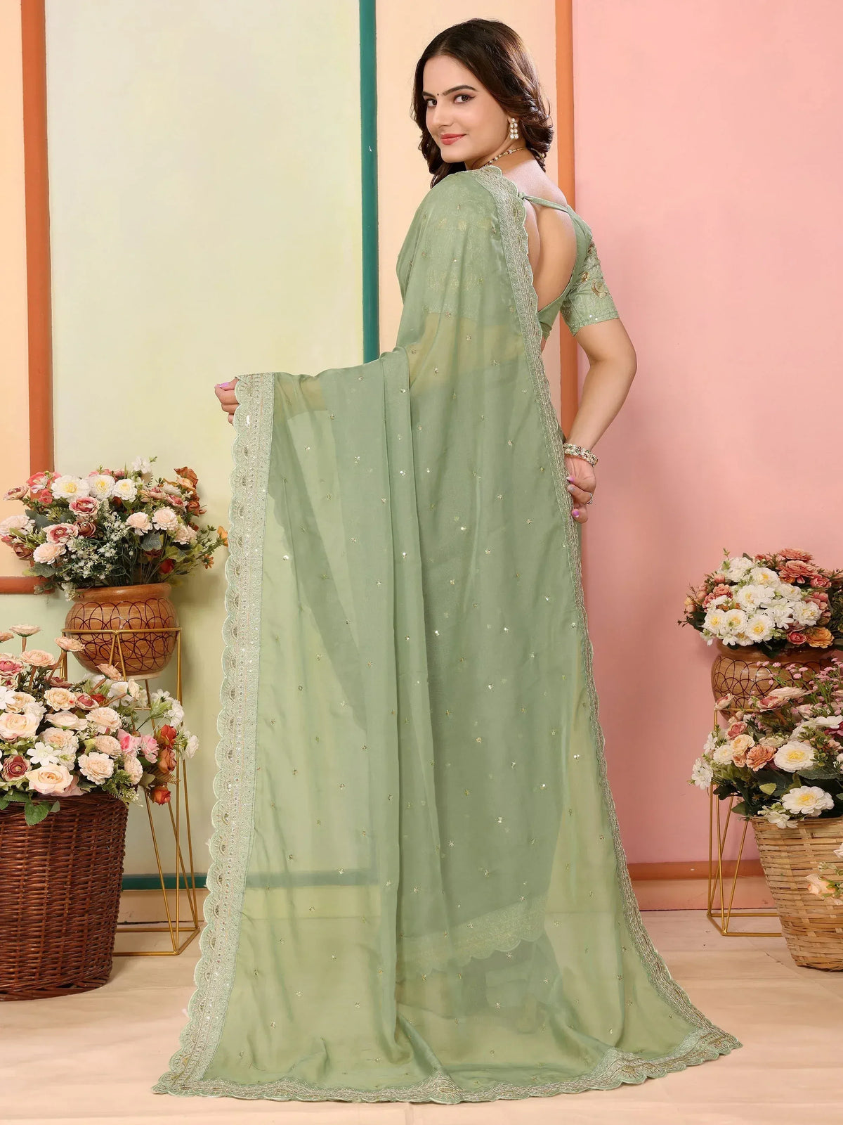 Mint green designer saree with sequin work and scalloped border, perfect for ethnic occasions