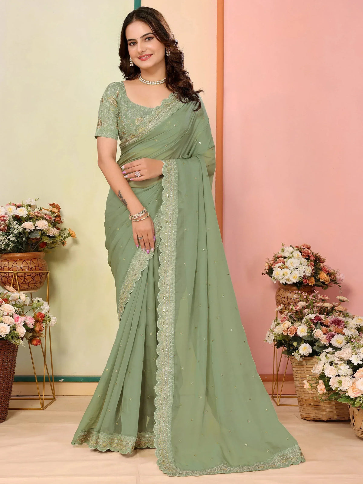 Elegant sage green saree with gold embroidery and scalloped border, perfect for Indian ethnic occasions