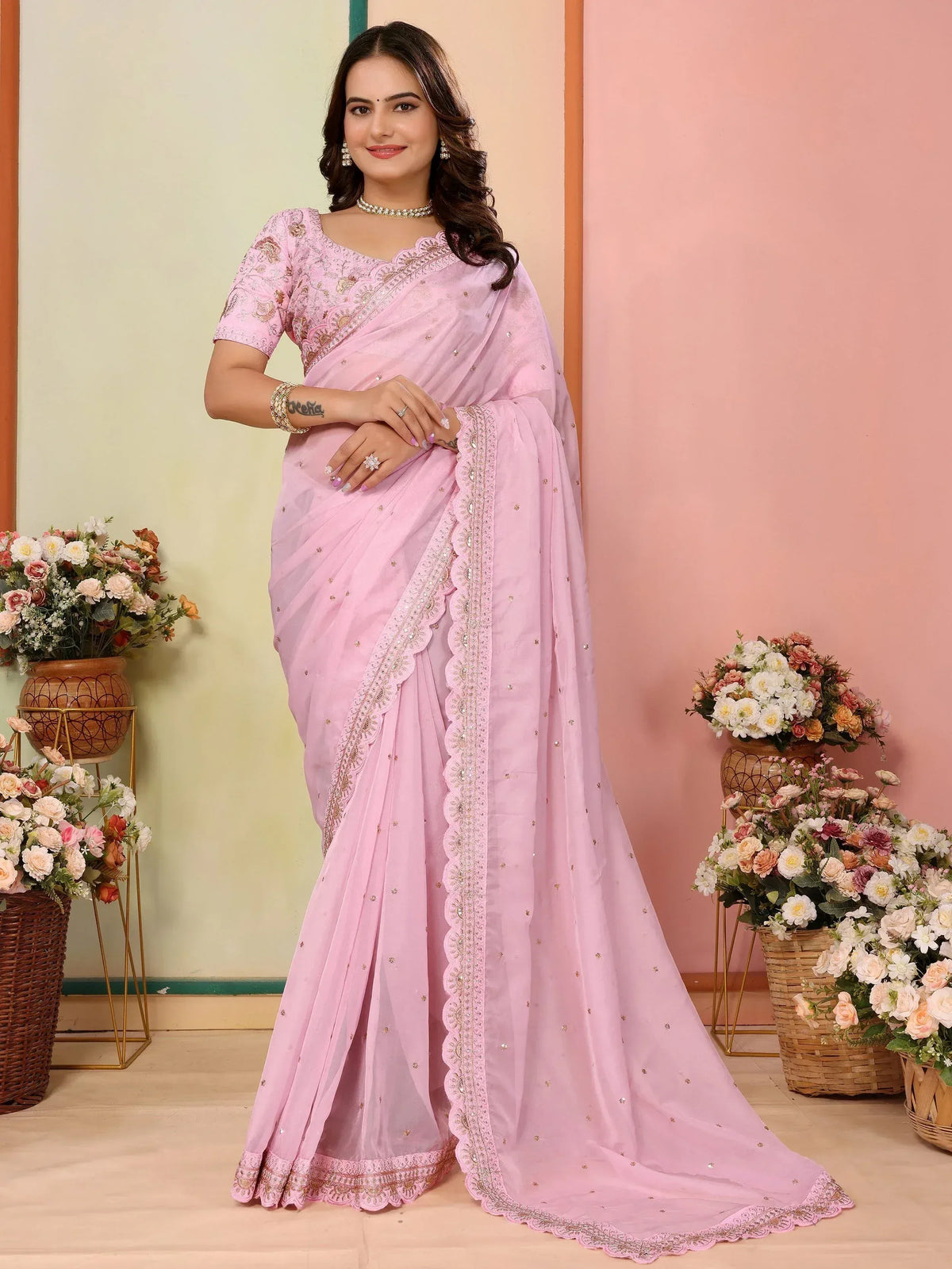 Pink embroidered saree with scalloped border, perfect for Indian ethnic occasions and festive wear.