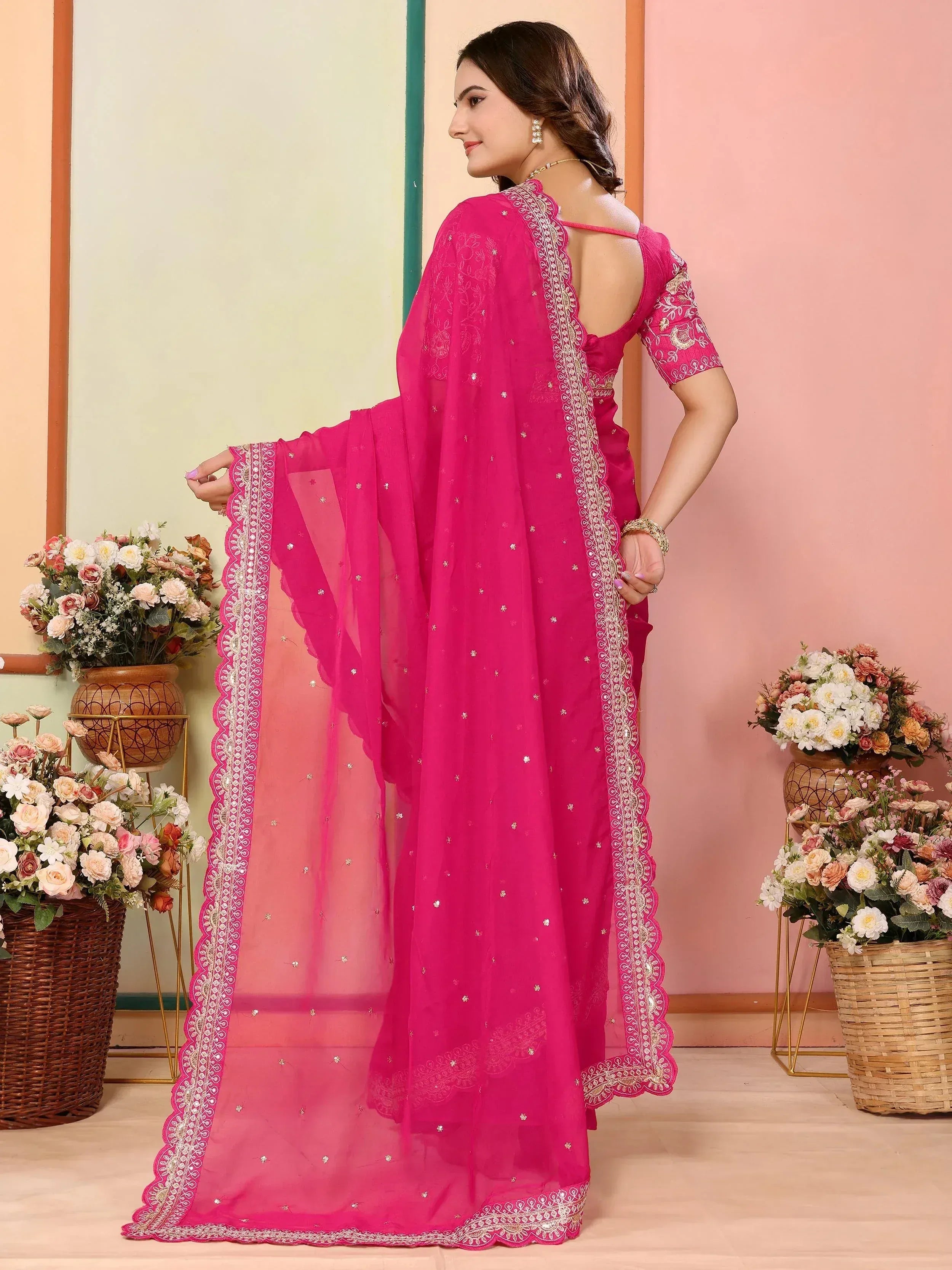 Pink embroidered saree with gold detailing and scalloped border, perfect for Indian ethnic wear occasions