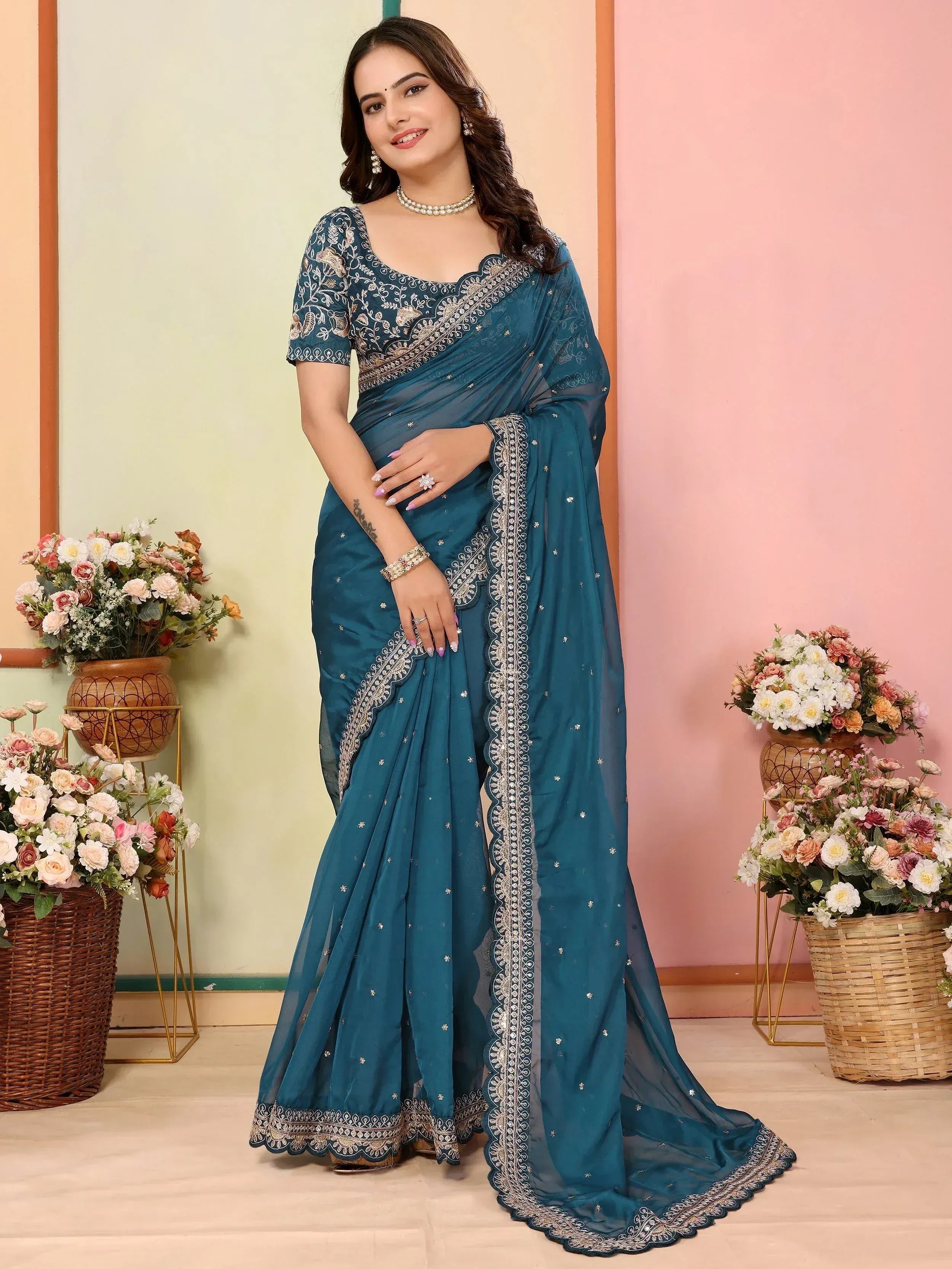 Teal embroidered saree with gold detailing, perfect for Indian ethnic occasions and festive wear.