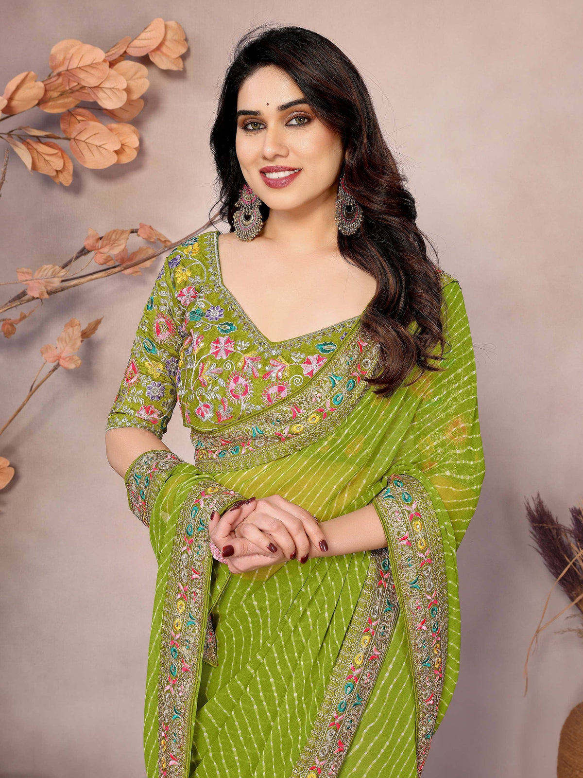 Green embroidered ethnic saree with floral motifs and matching blouse, perfect for Indian occasions