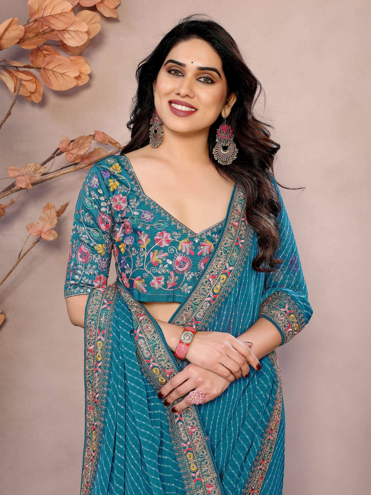 Teal embroidered ethnic saree with floral blouse, perfect for Indian occasions and festive wear.