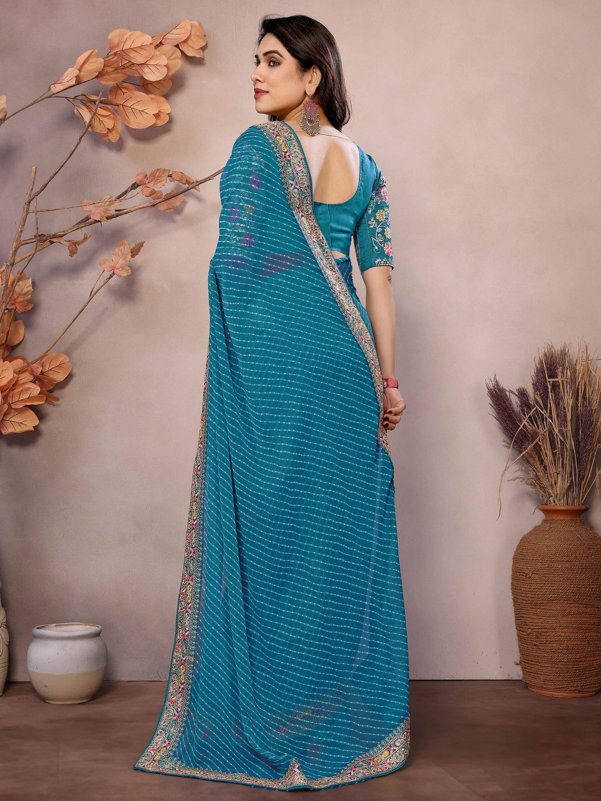 Teal embroidered saree with floral border and backless blouse, Indian ethnic wear