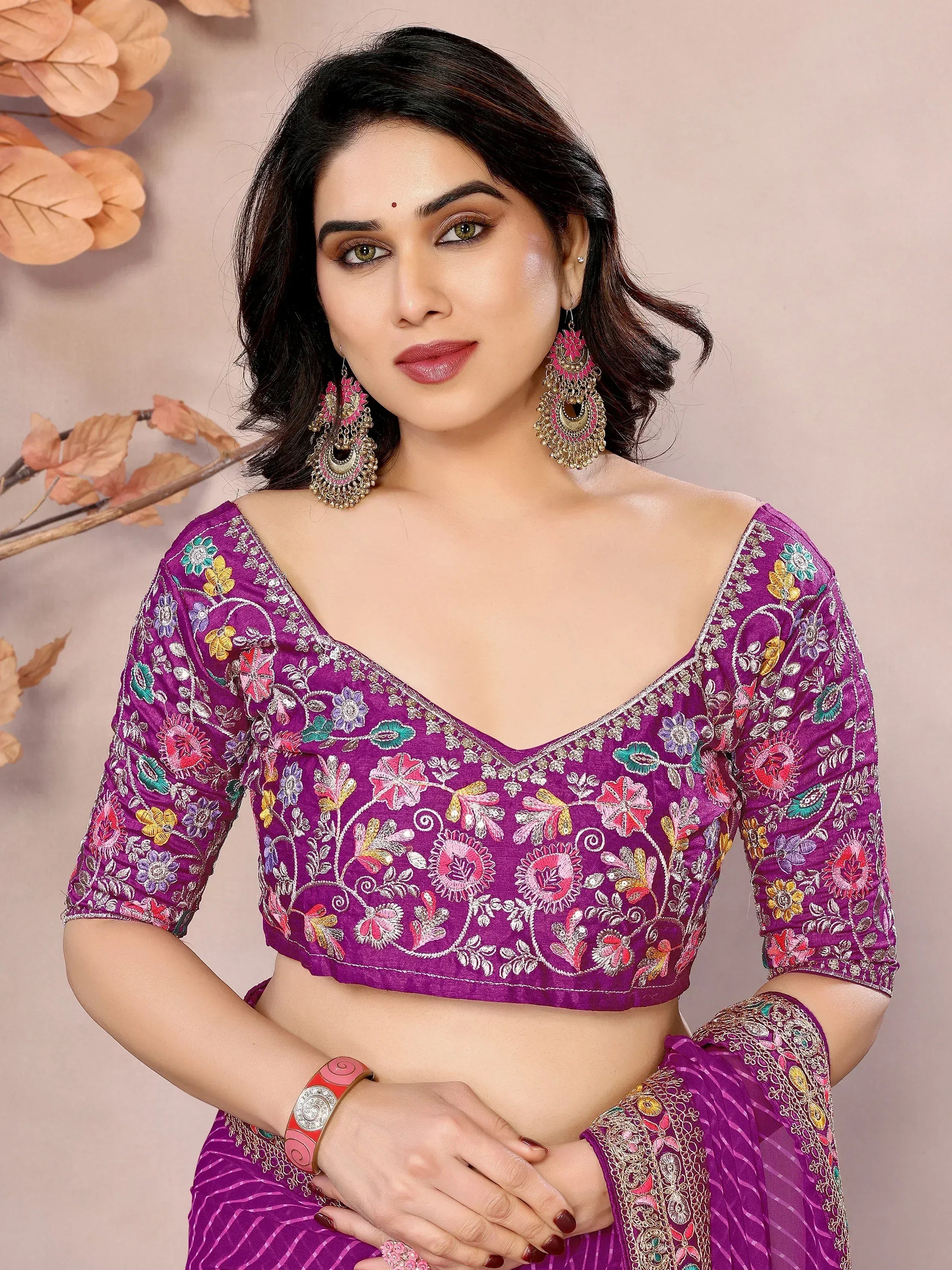 Purple floral embroidered saree blouse with V-neck, 3/4 sleeves, paired with matching saree and statement earrings