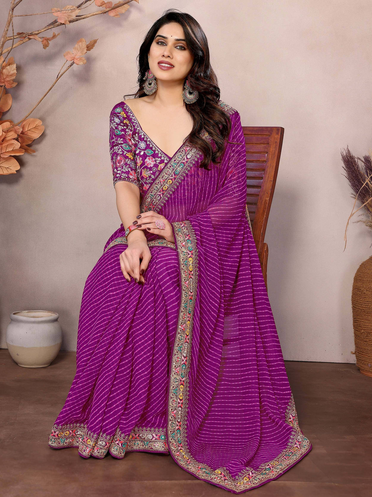 Purple embroidered saree with floral designs and striped patterns, perfect for ethnic occasions.