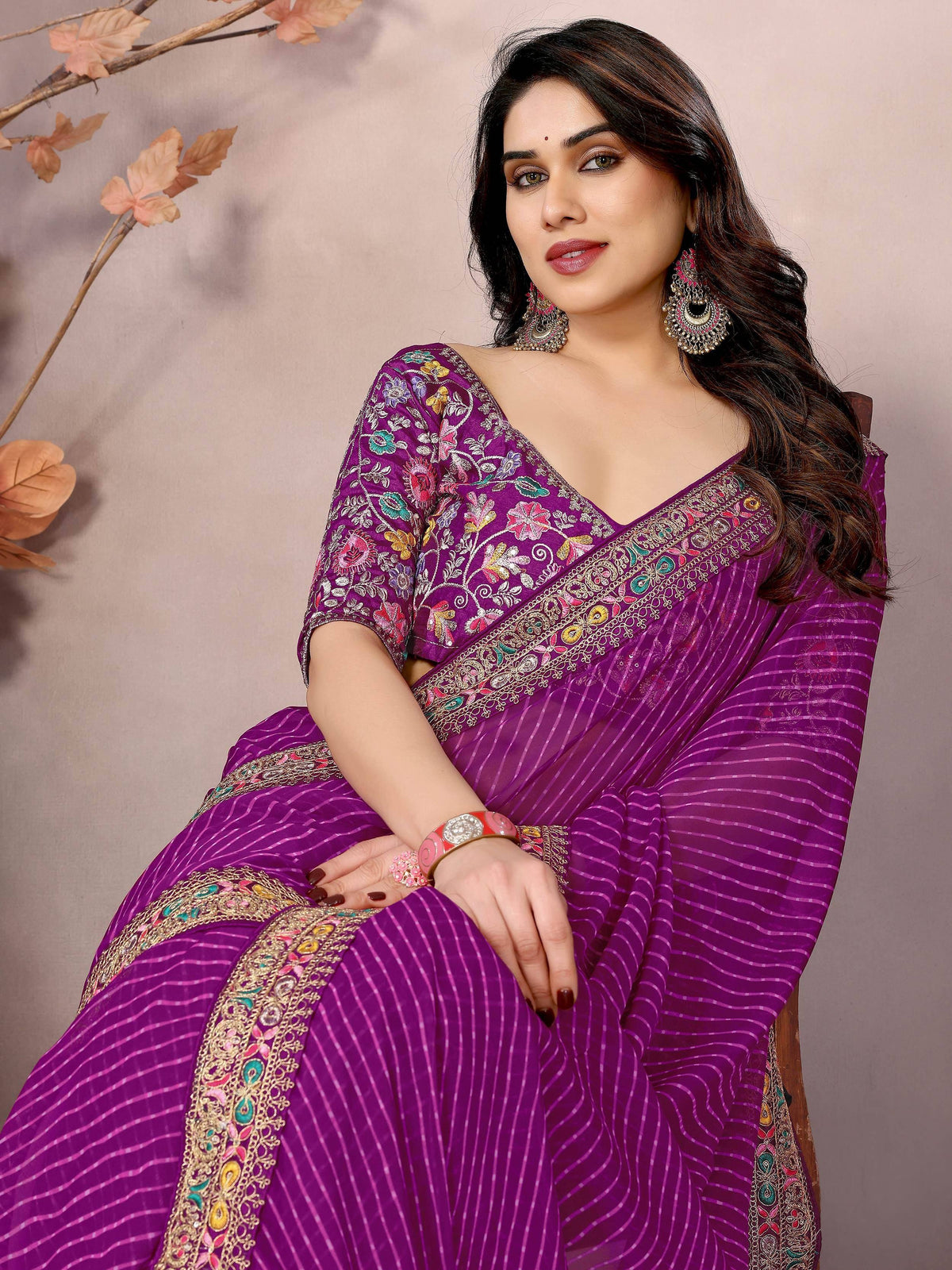 Purple embroidered saree with floral motifs and zari border, perfect for Indian ethnic occasions.