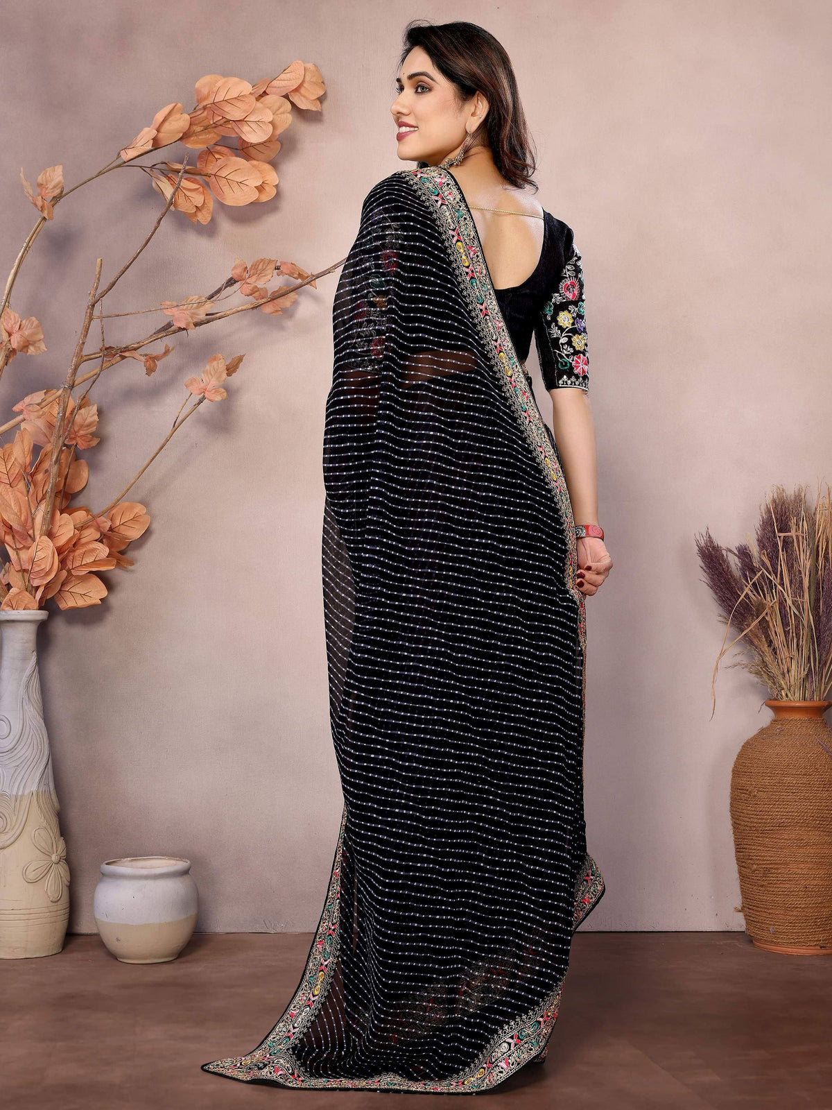 Black striped saree with floral embroidery, perfect for Indian ethnic wear occasions