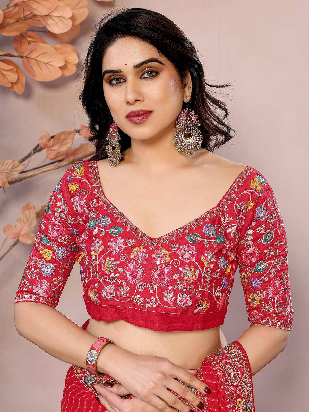 Red floral embroidered blouse with ethnic jewelry for Indian wear