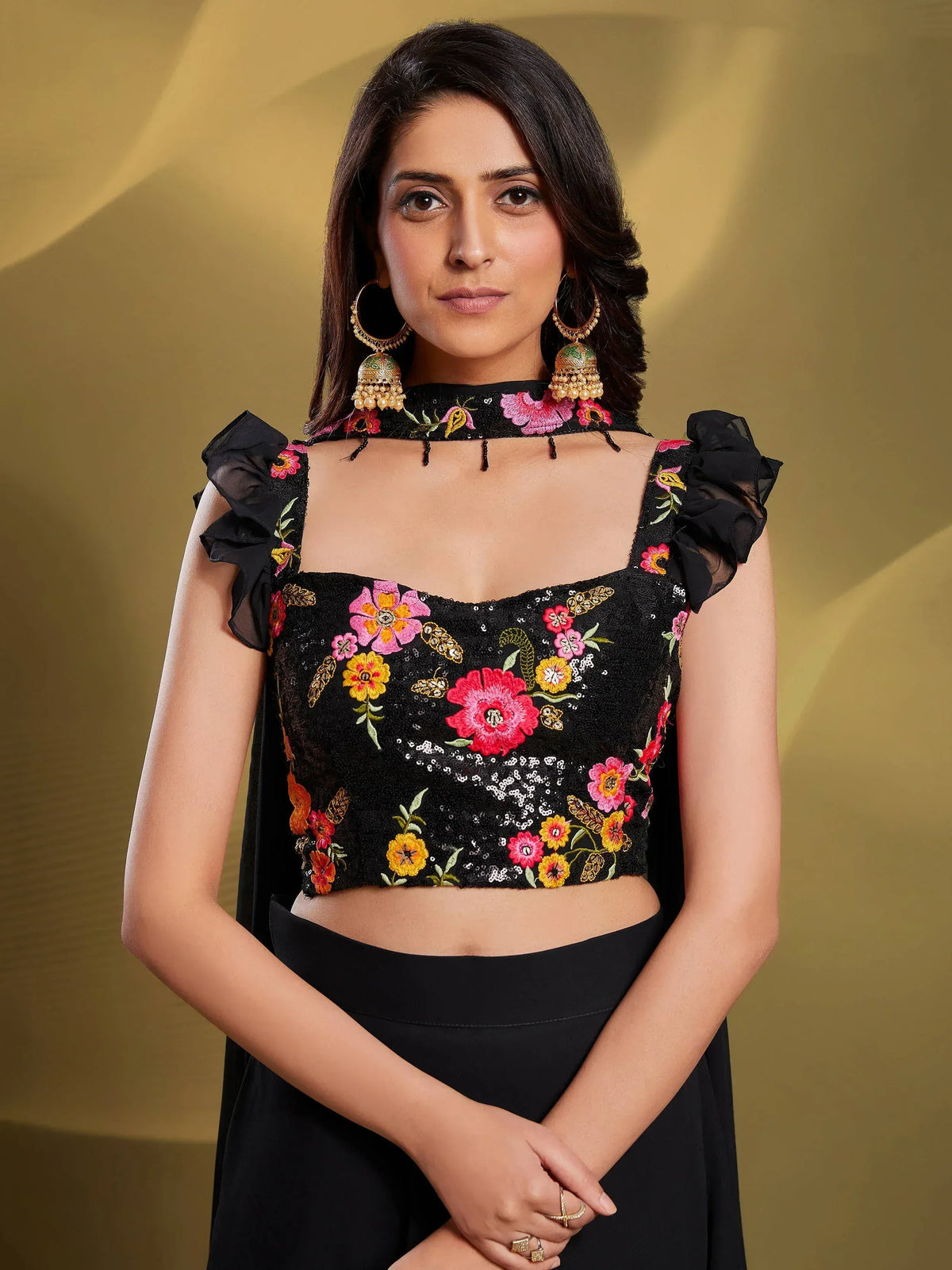Black floral embroidered crop top with ruffled sleeves and choker, paired with ethnic skirt