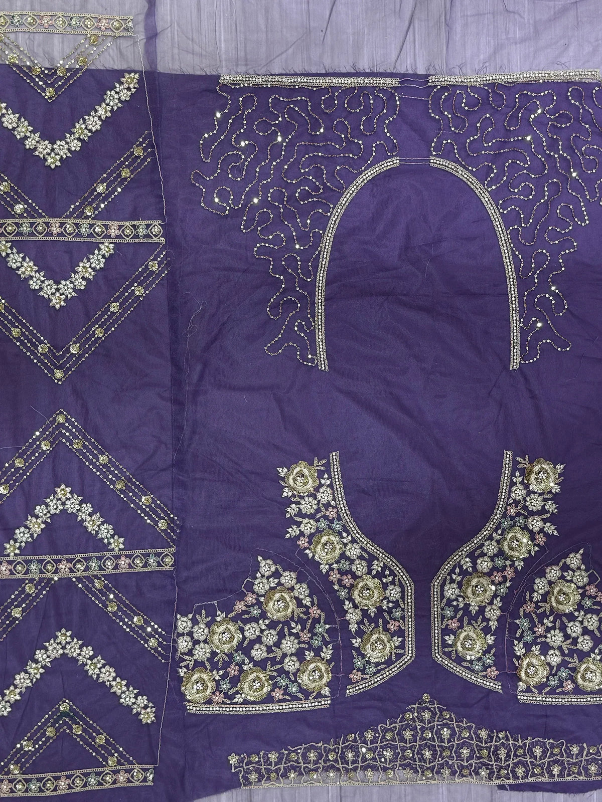 Purple ethnic wear with intricate floral embroidery and embellished borders