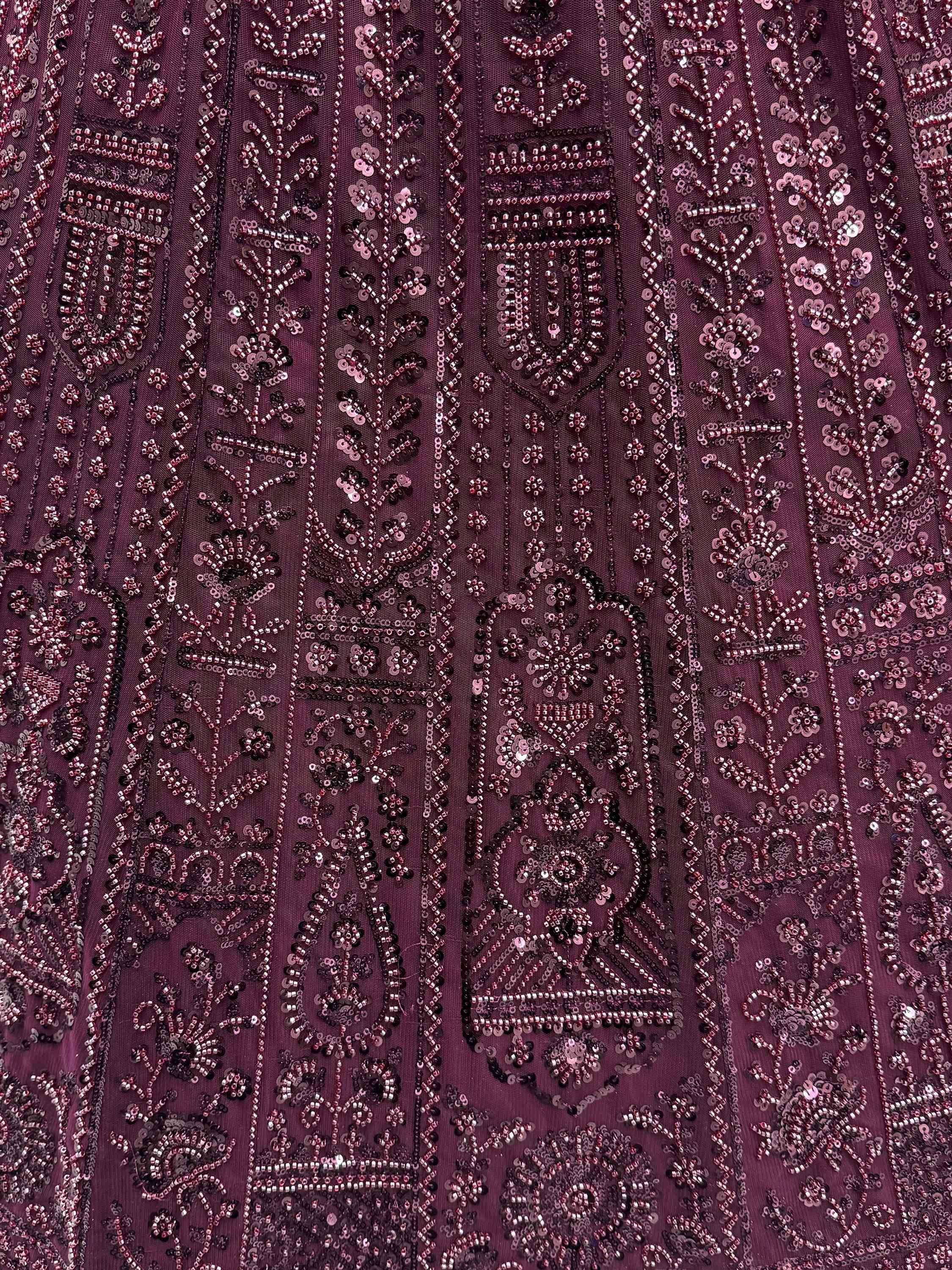 Richly embroidered maroon ethnic wear with intricate sequin and beadwork patterns