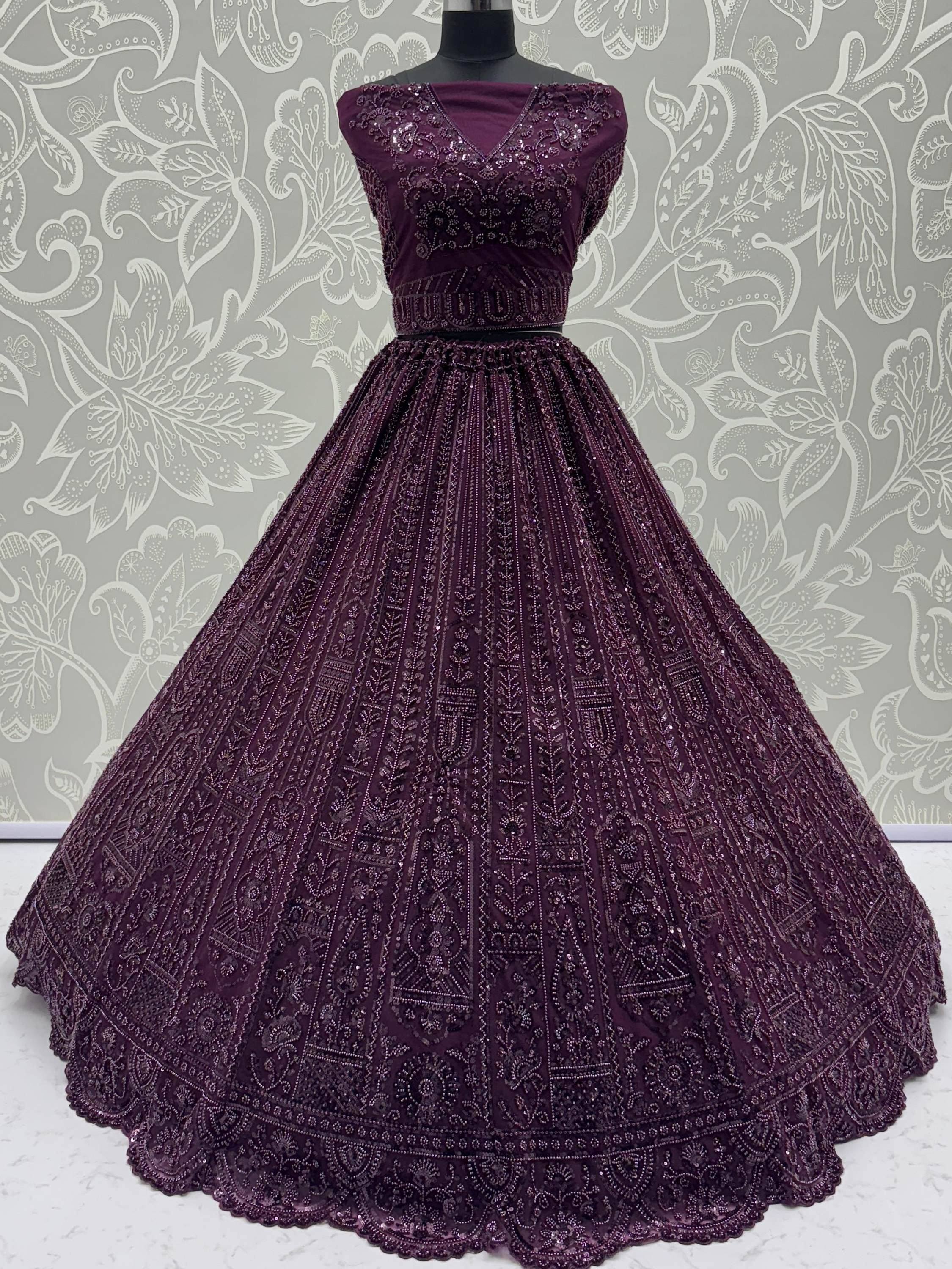 Elegant purple ethnic gown with intricate beadwork and flared skirt, perfect for Indian celebrations