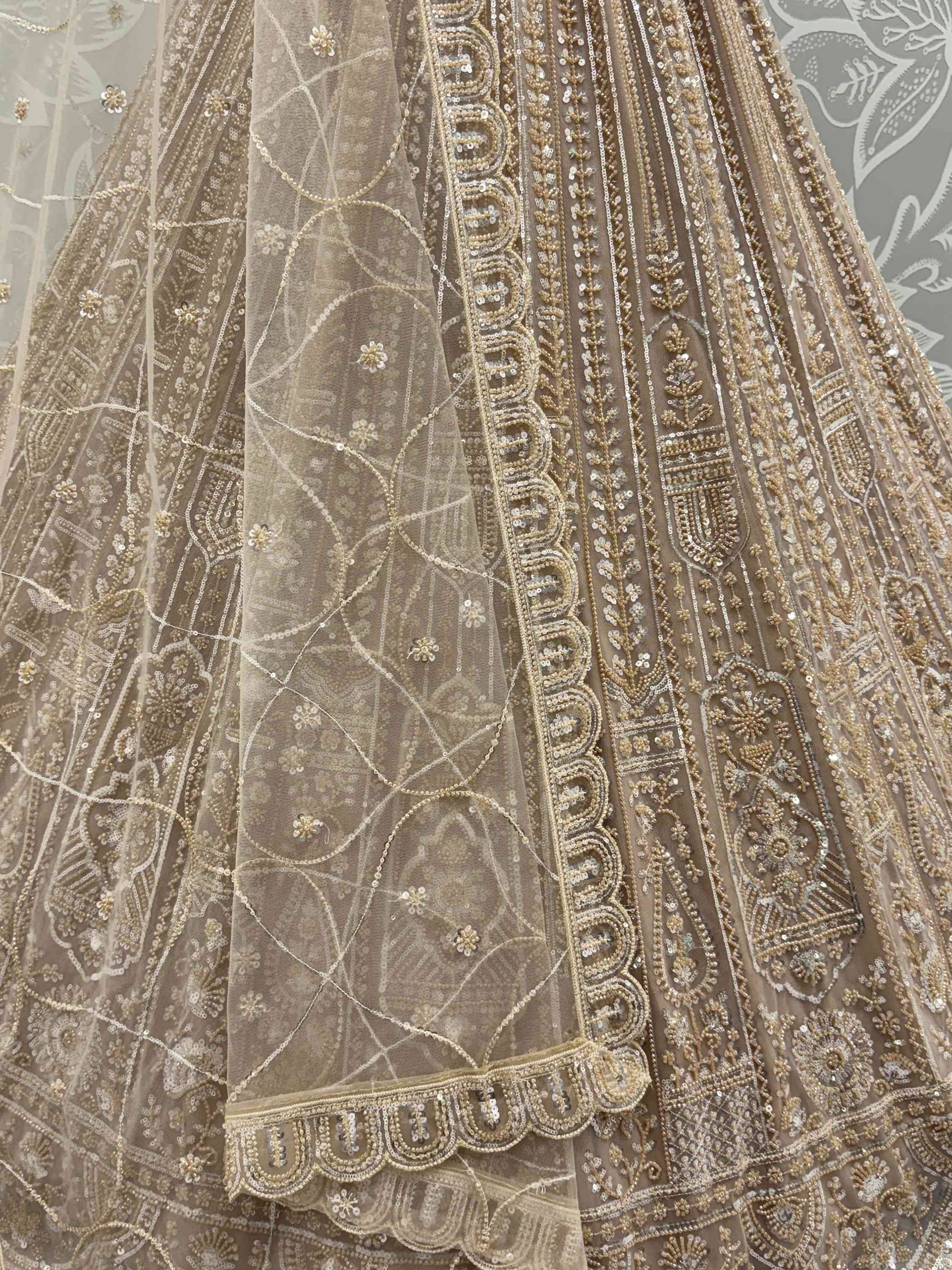 Beige designer lehenga choli with intricate gold embroidery and sequin work for Indian ethnic wear