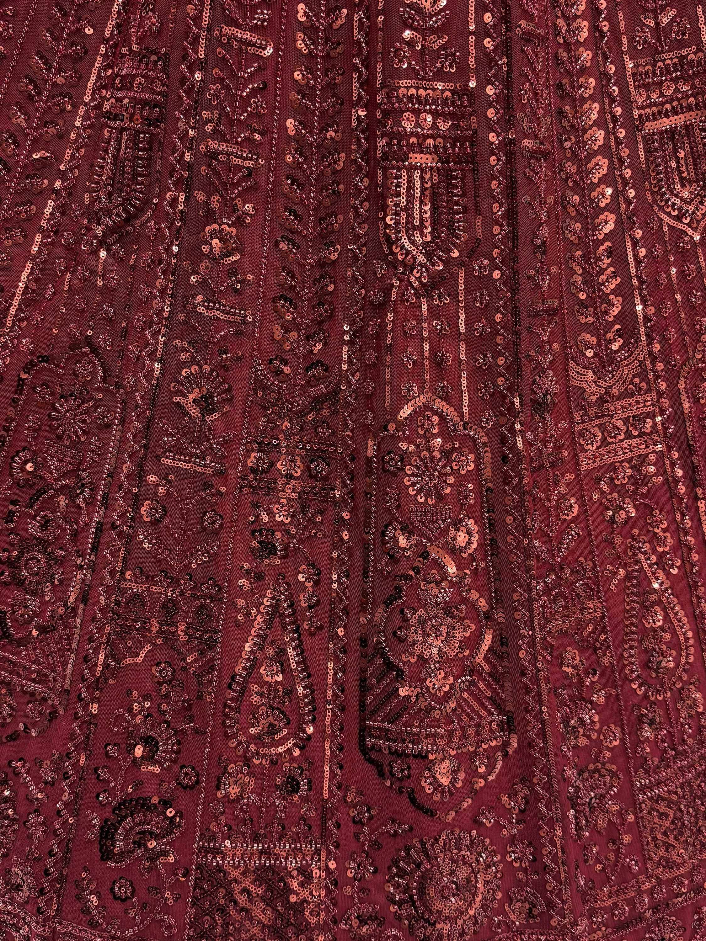 Rich maroon ethnic gown with intricate sequin embroidery and floral patterns for festive occasions