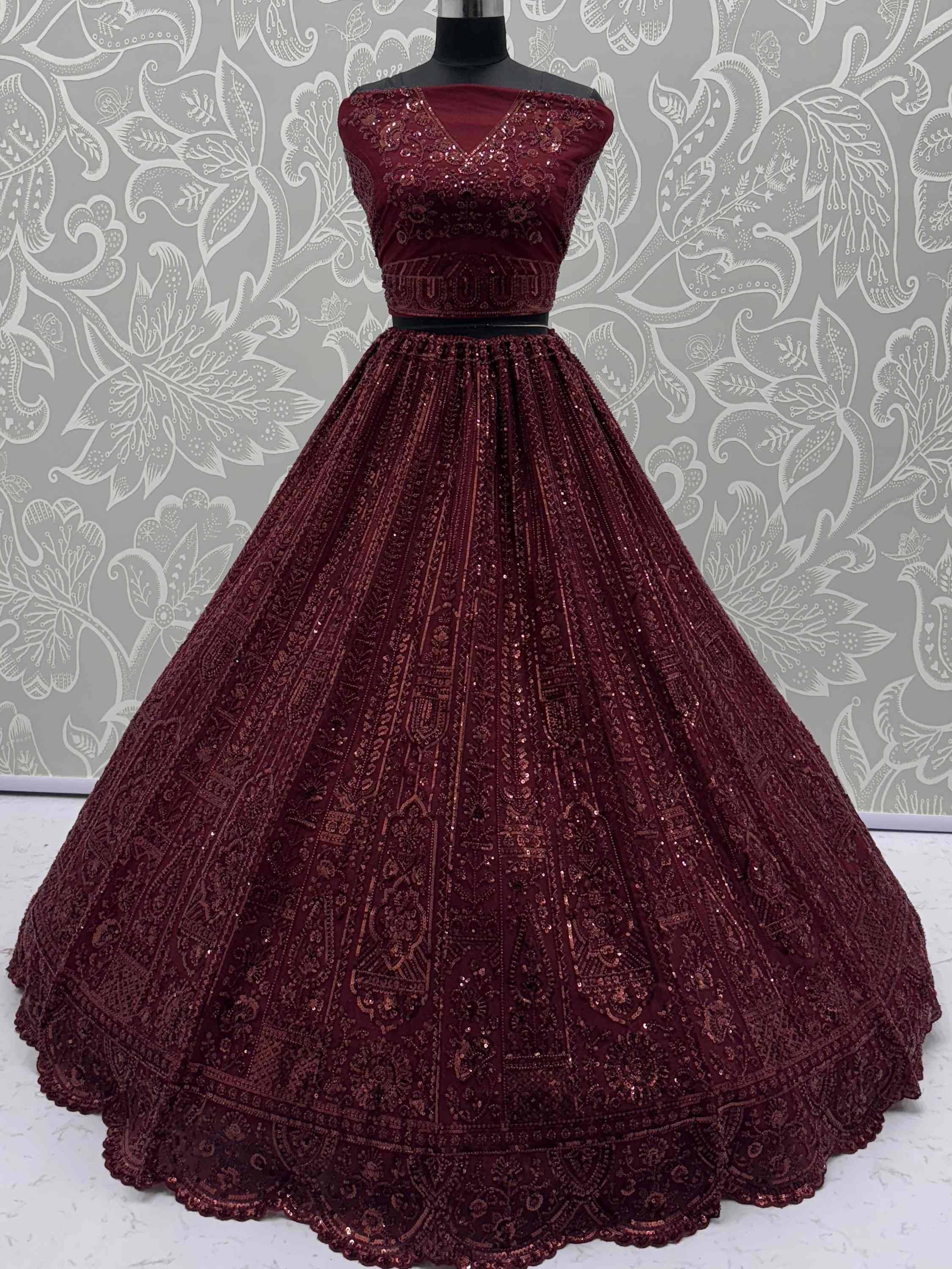 Burgundy designer lehenga choli with heavy sequin embroidery, perfect for weddings and festive occasions.