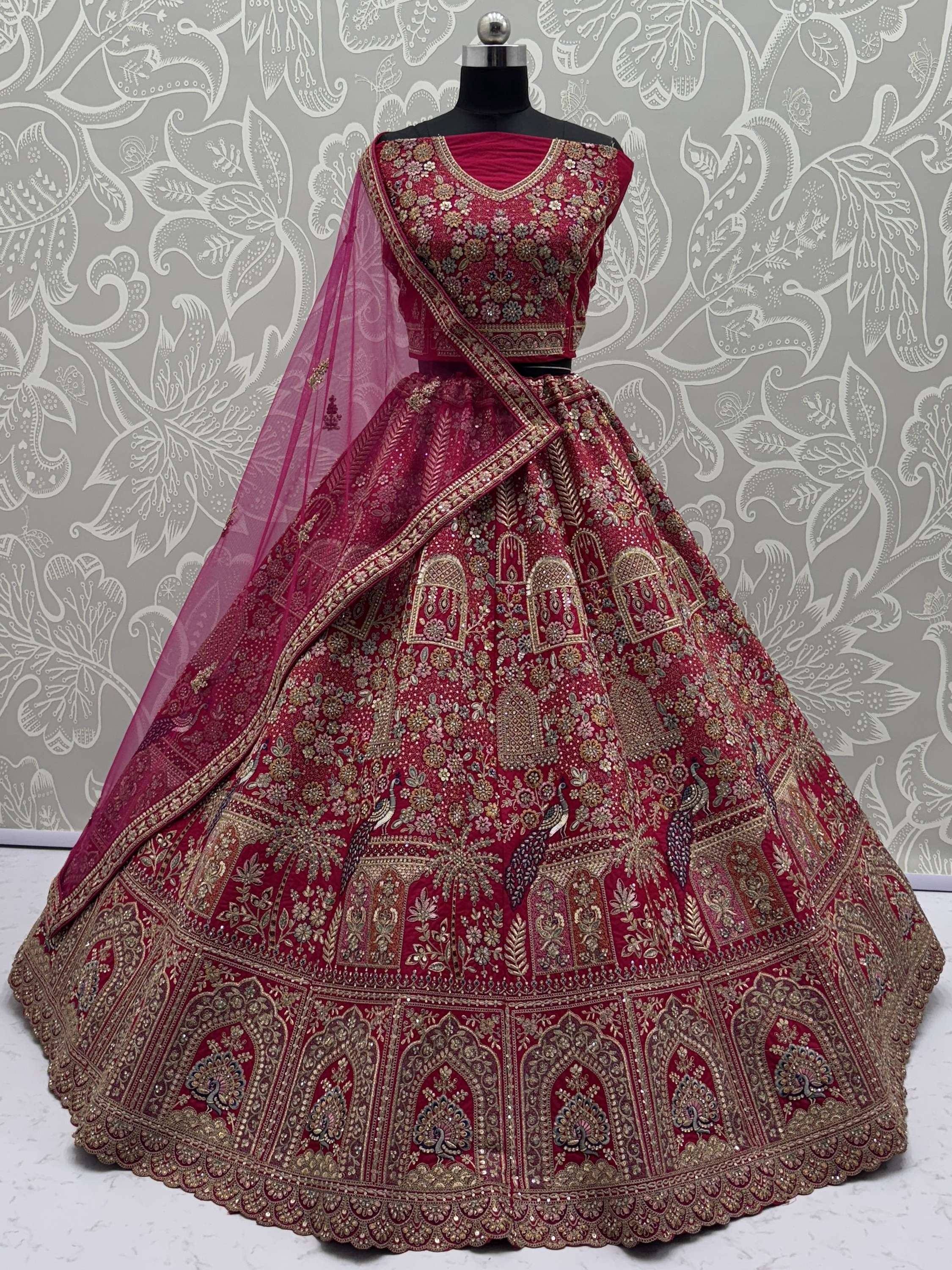 Maroon designer lehenga choli with heavy gold embroidery and peacock motifs, perfect for Indian weddings.