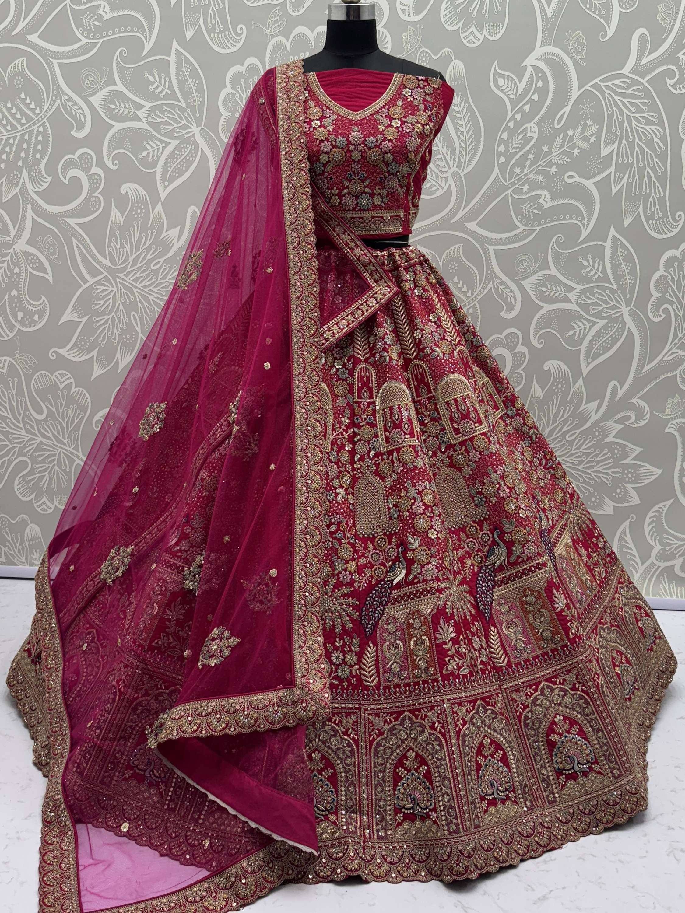Luxury maroon lehenga choli with heavy gold embroidery and peacock motifs, perfect for weddings and festivals.