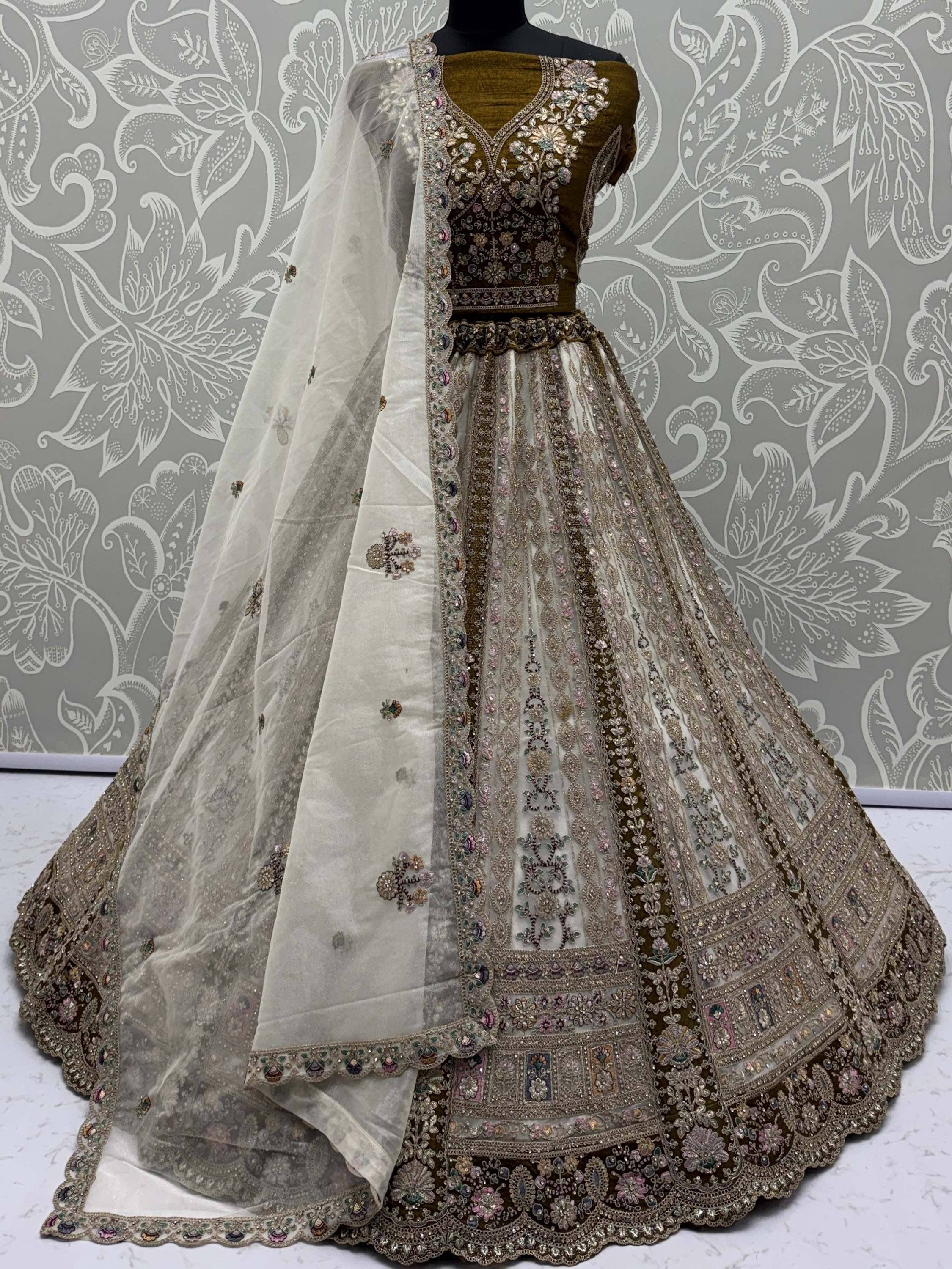 Elegant designer lehenga choli with intricate embroidery and sheer dupatta, perfect for Indian ethnic wear.