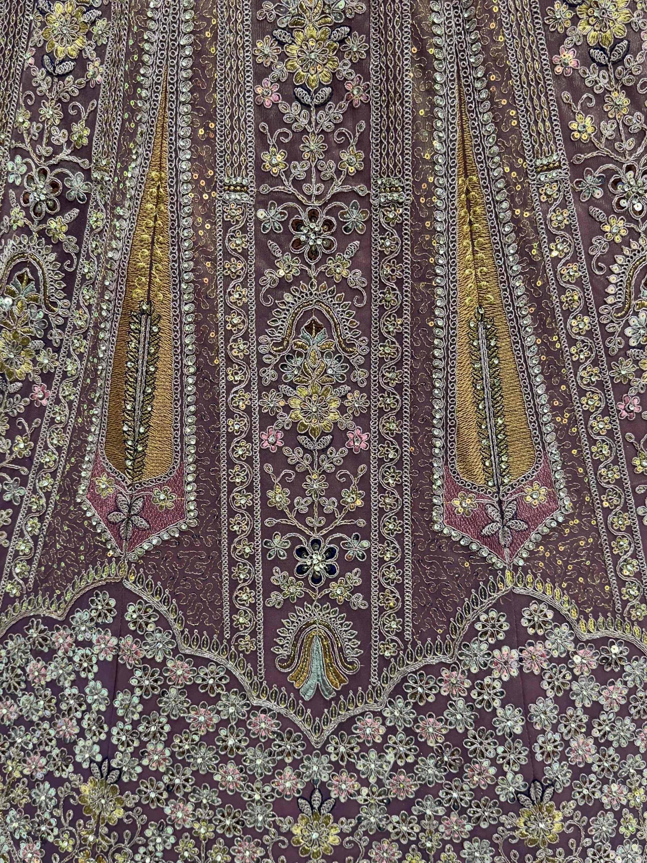 Elegant purple ethnic gown with intricate gold floral embroidery and sequin detailing for festive occasions