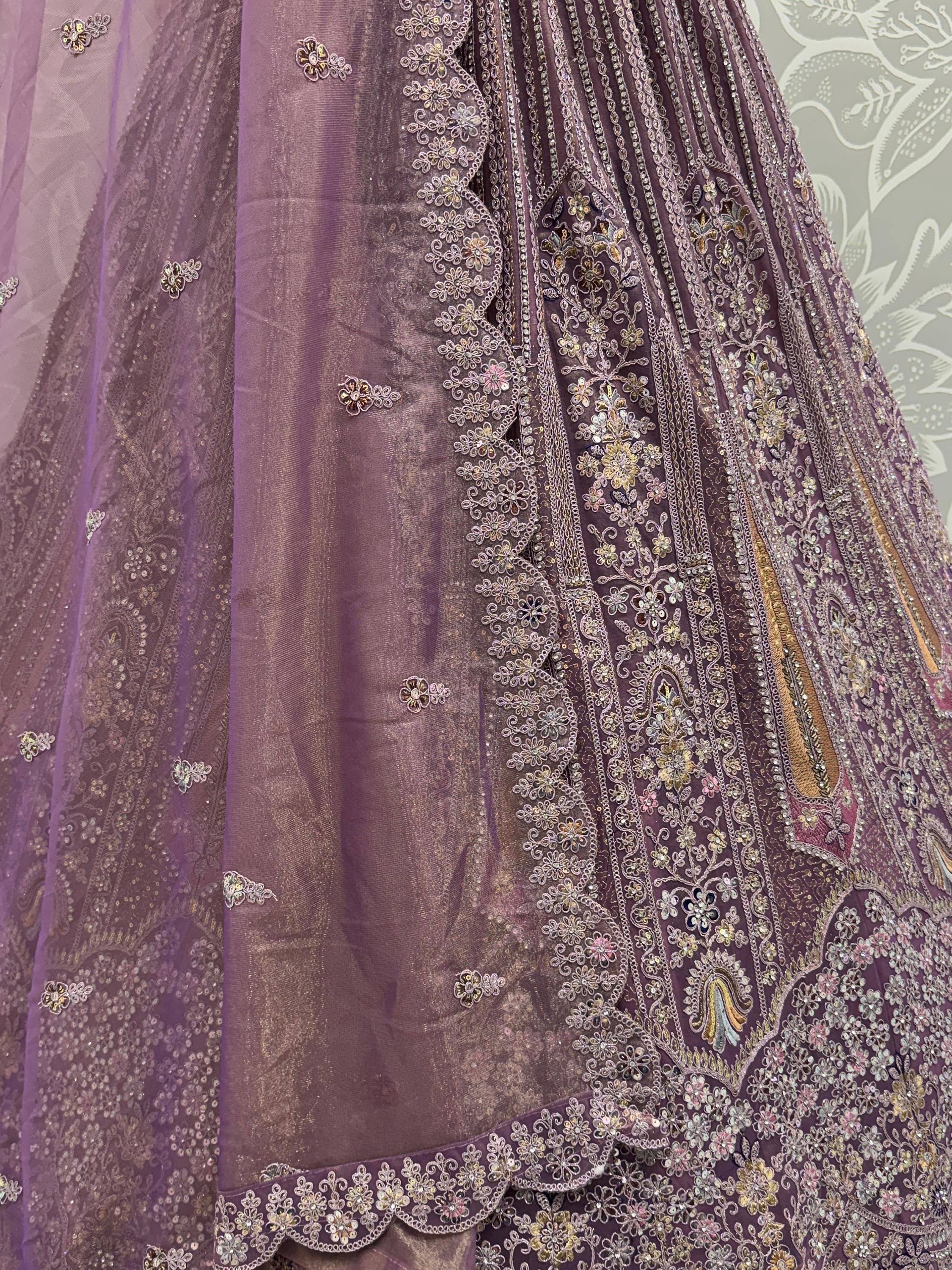 Purple designer lehenga choli with intricate floral embroidery and sequin detailing for Indian ethnic wear