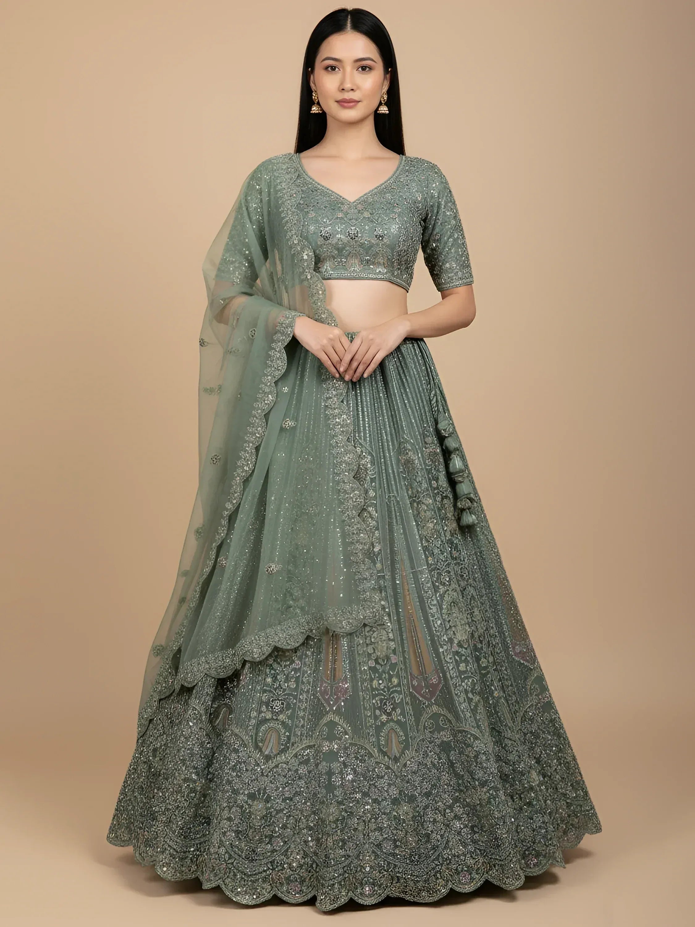 Elegant sage green designer lehenga choli with intricate embroidery and sequin work, perfect for weddings and festive occasions.