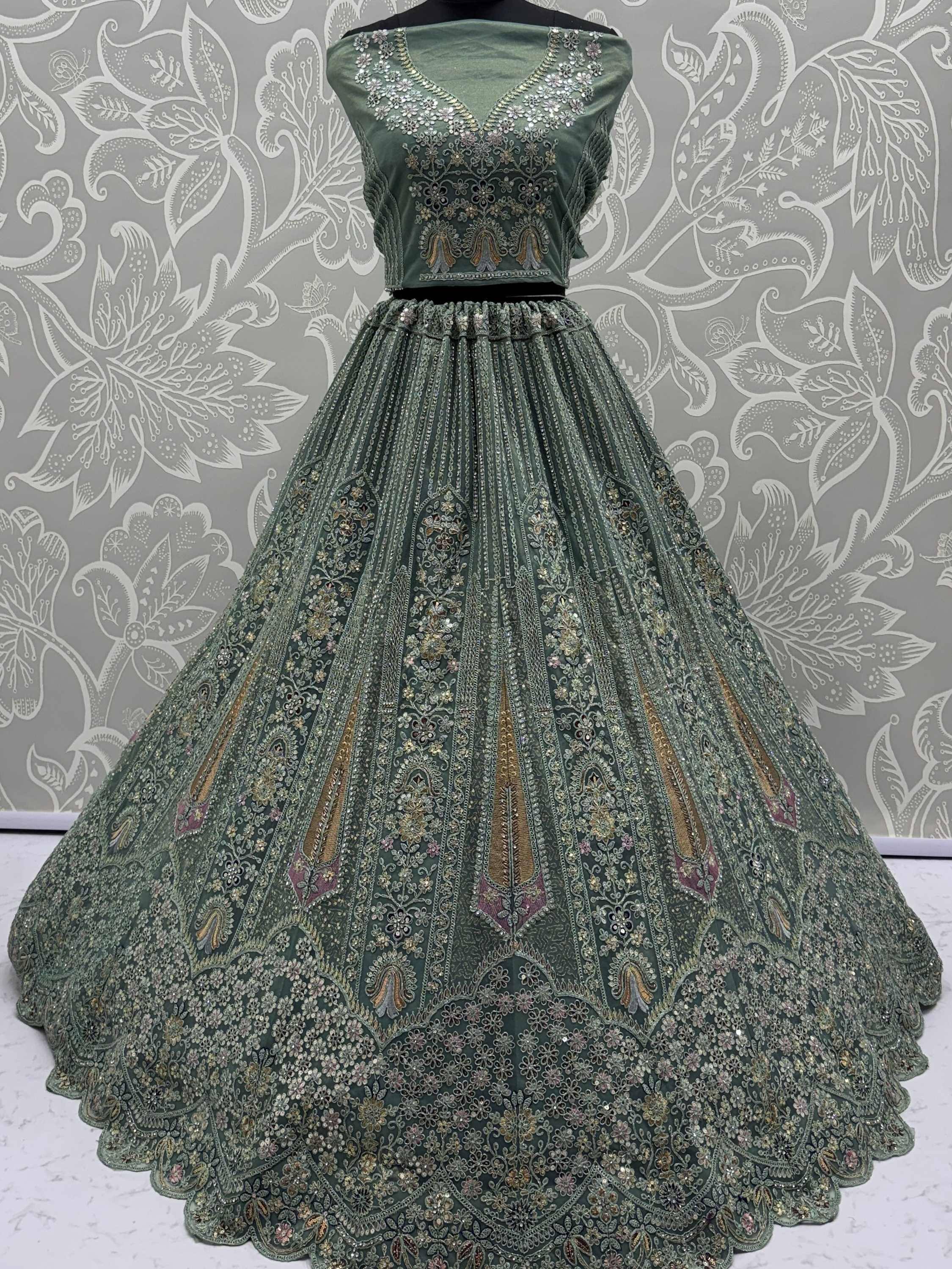 Emerald green designer lehenga choli with heavy embroidery and sequins, perfect for weddings and festive occasions.