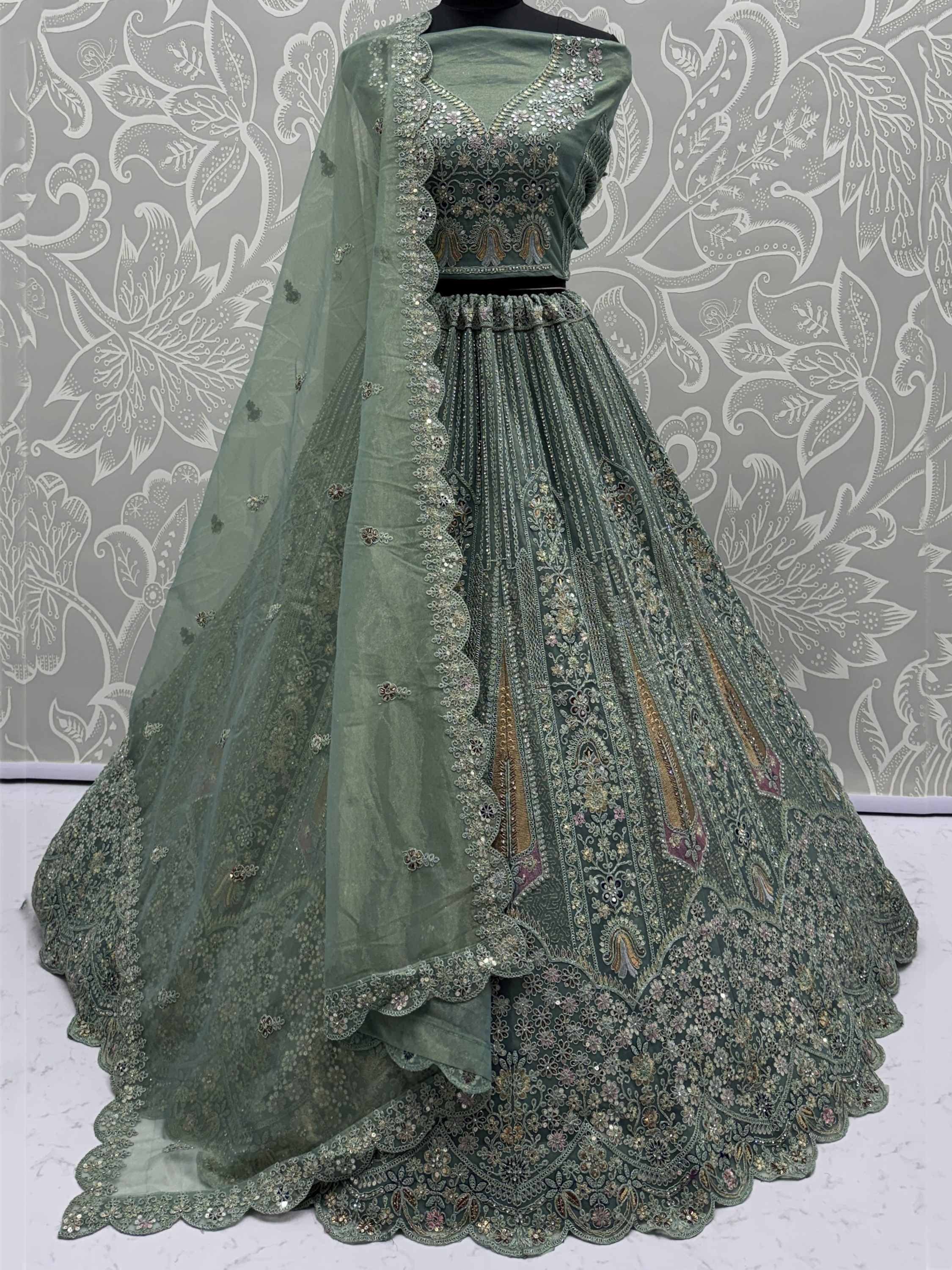 Emerald green designer lehenga choli with heavy embroidery and scalloped dupatta, perfect for Indian weddings and parties.